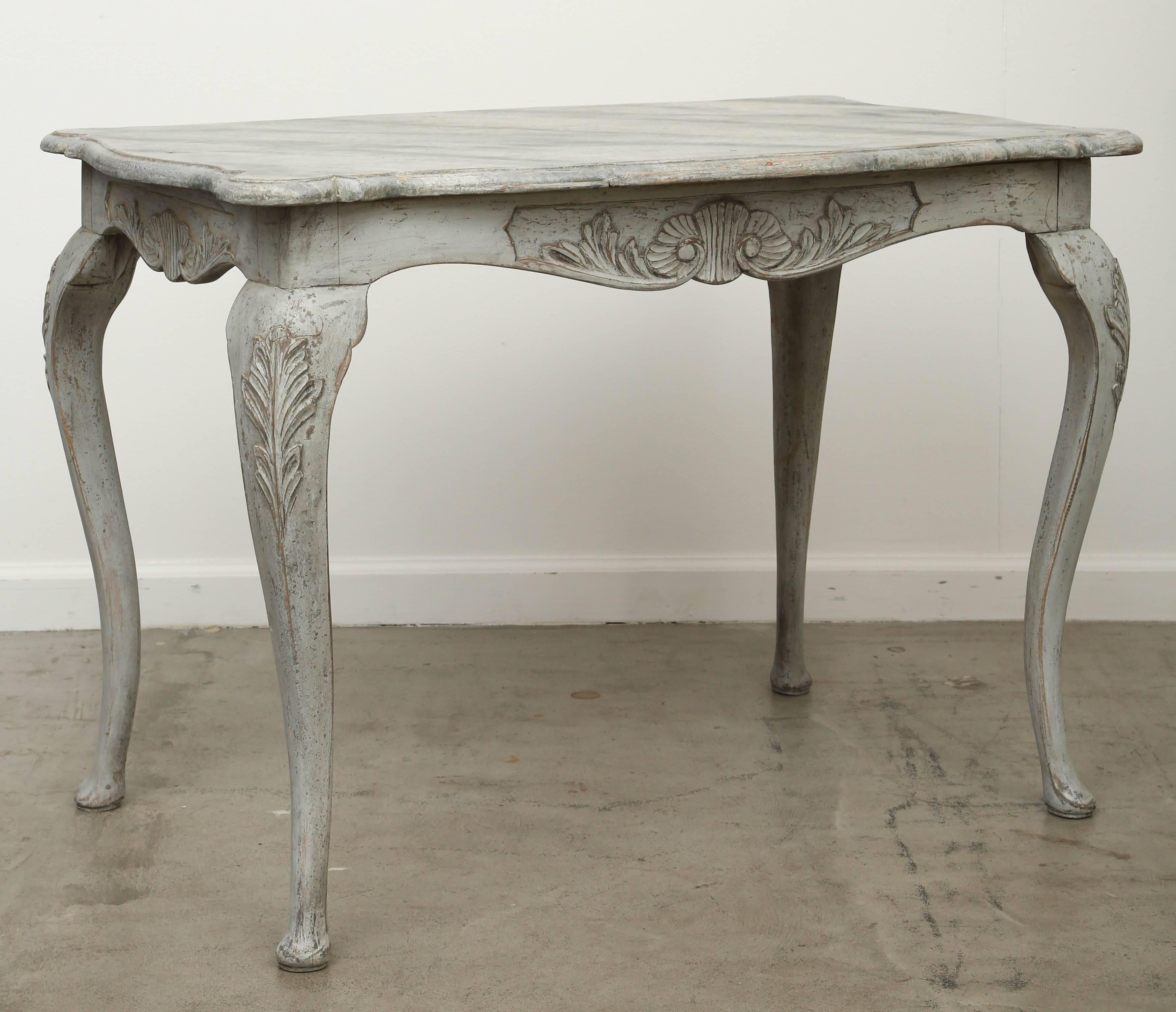 Antique Swedish Rococo carved large painted table with faux marble top
early 19th century.
A very elegant large Swedish Rococo table with lovely carved cartouches on the apron and curved legs, top is gray faux marble distressed finish.  Base is gray