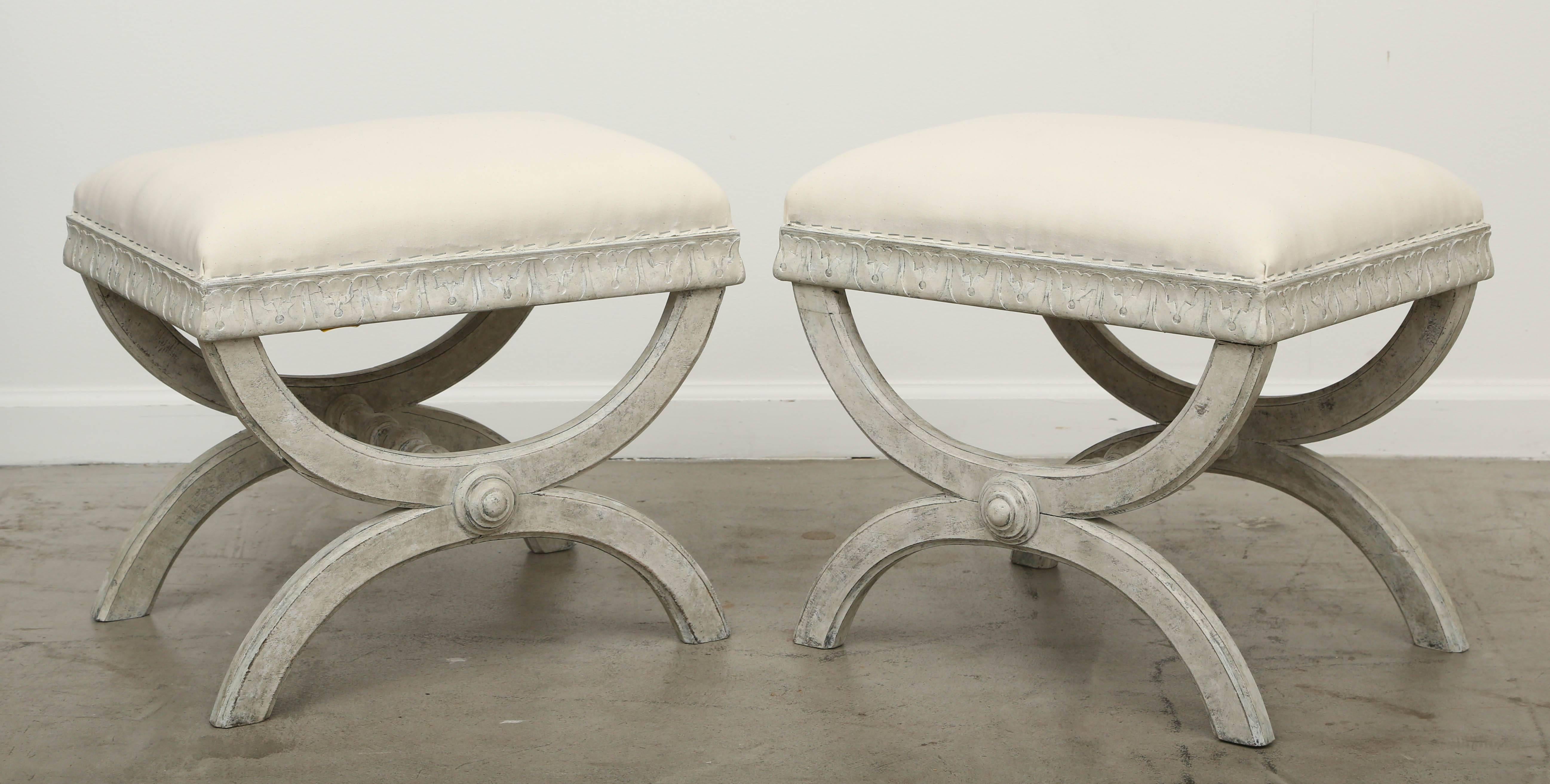 Pair antique Swedish Gustavian style Painted   X-base stools, early 19th century.
Painted in a Swedish grey distressed finish, lovely acanthus leaf border below upholstery,
round carved medallion at X of legs and turned carved stretchers.

Measures: