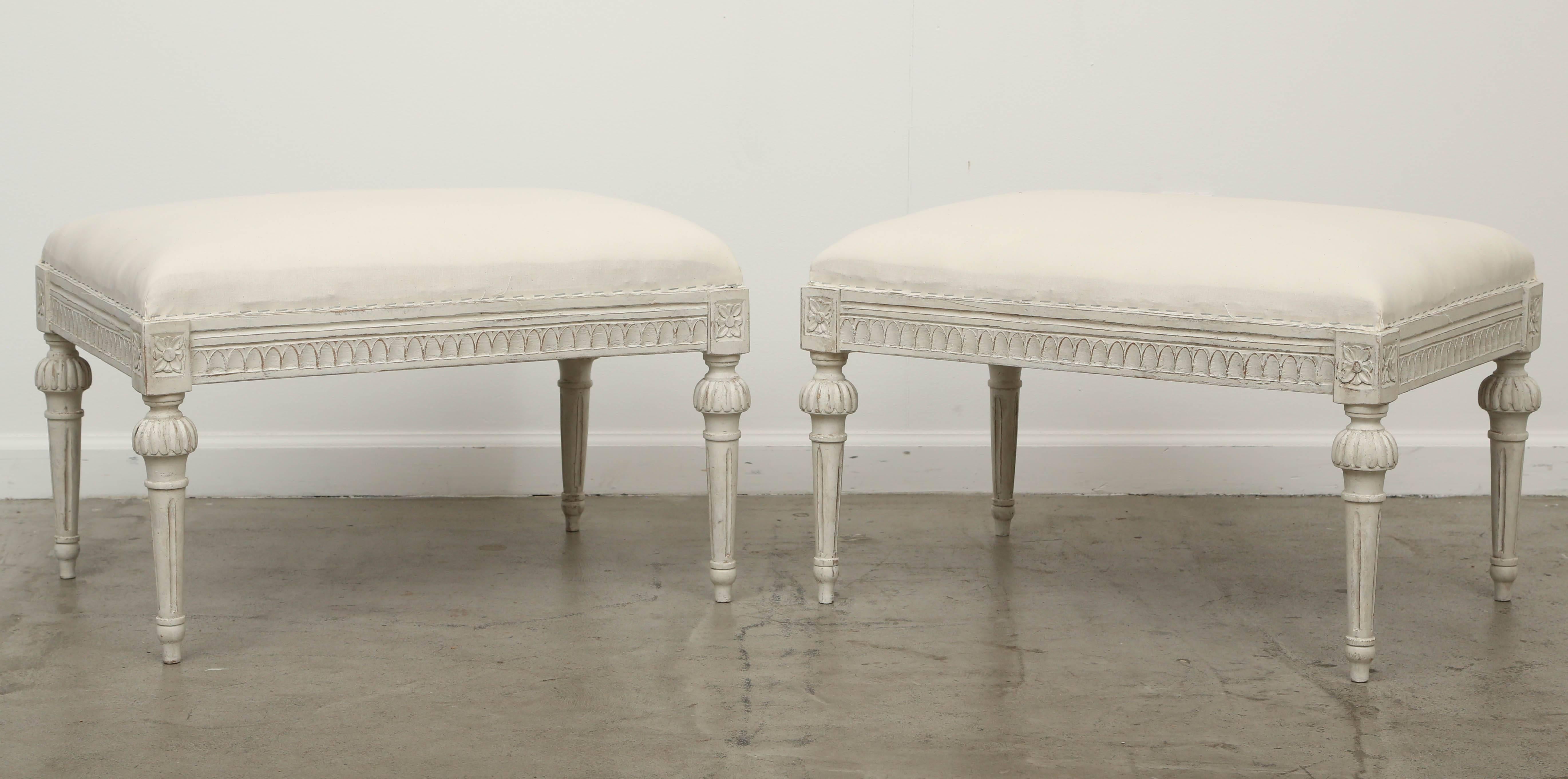 One Swedish painted Gustavian bench, late 19th century.
Bench is a larger scale, with carved lambs tongue border on apron, round tapered fluted legs with round ball fluted cap on top of legs, carved rosettes top of each leg, painted in white- grey