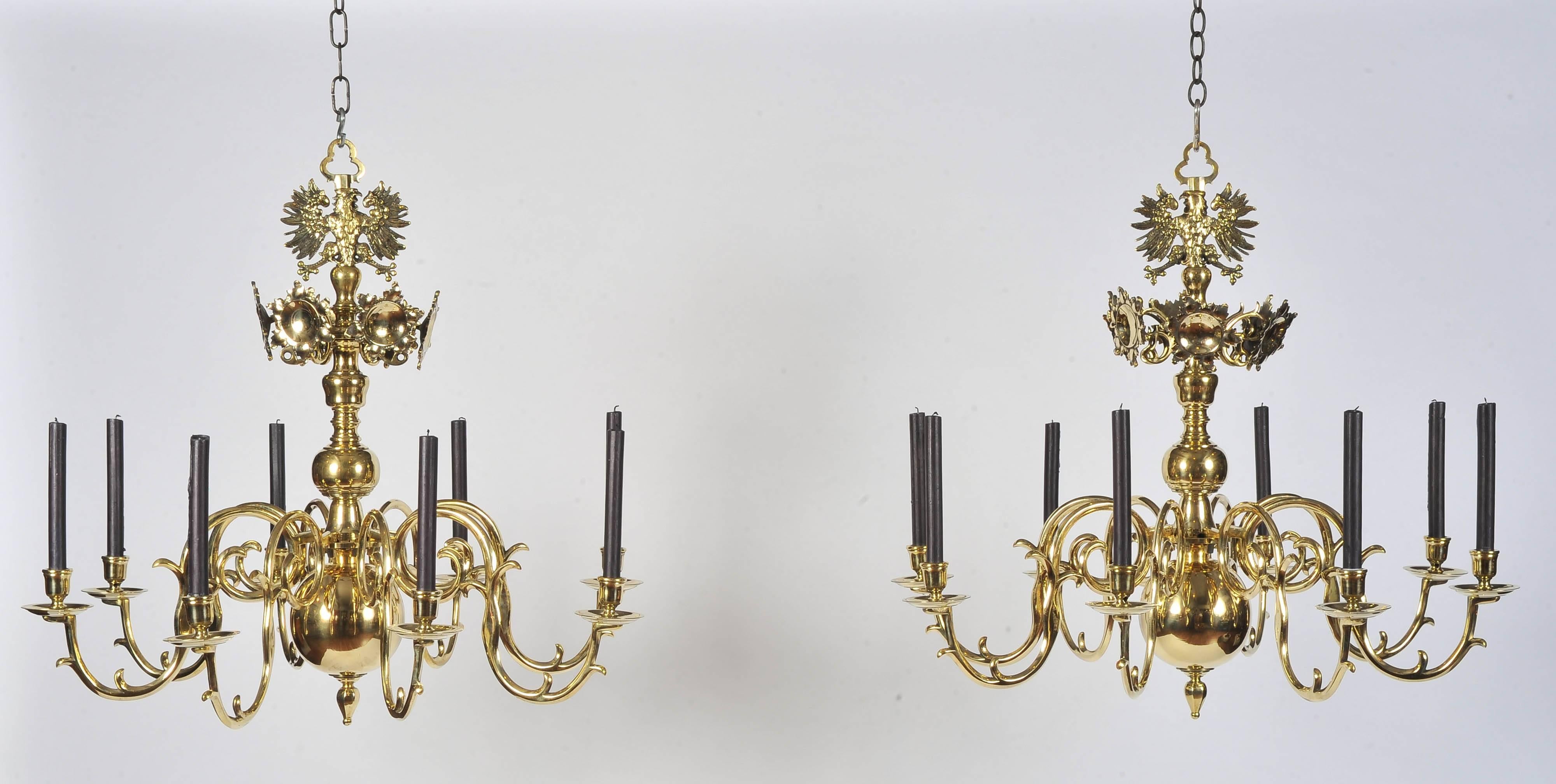 A stunning pair of mid-19th century eight-branch brass chandeliers.
Each of solid brass 