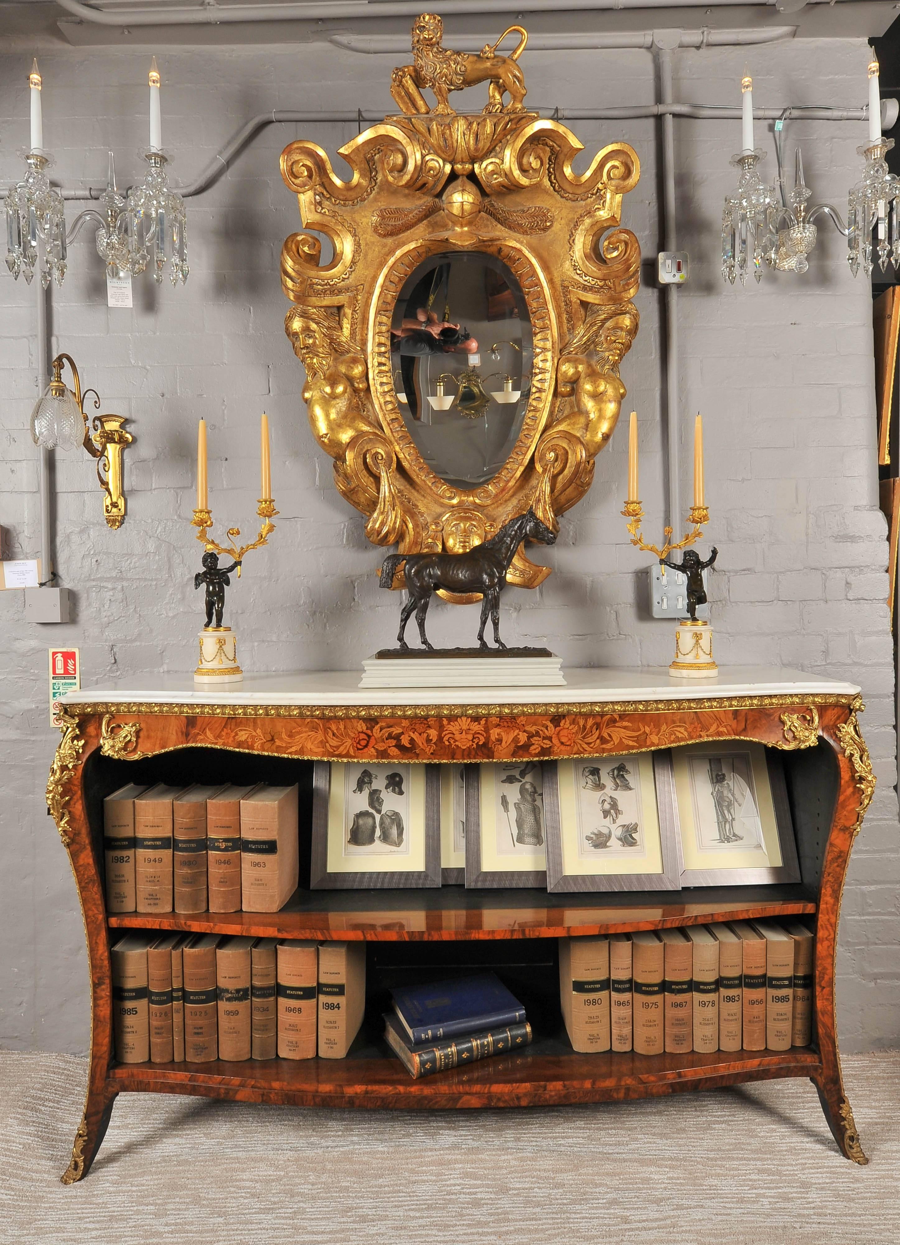 A fine mid-19th century walnut and marquetry serpentine front open bookcase with fabulous ormolu mounts throughout and a white marble top; an adjustable shelf and standing of elegant splay feet.
To the quality and style of Gillows.