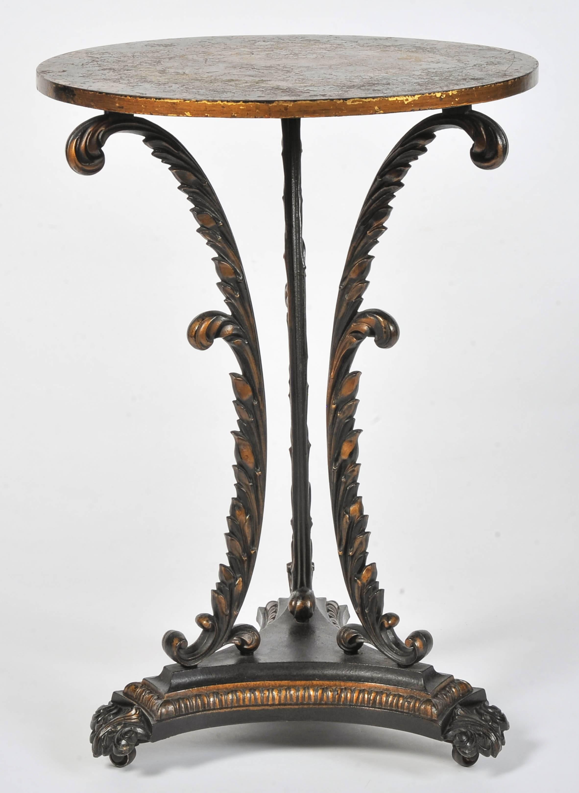 A most unusual early 19th century iron tripod table, the three frondular supports on a triform base with mouldings and feet to the designs of George Smith and retaining the original parcel gilding throughout. The quality of Coalbrookdale.