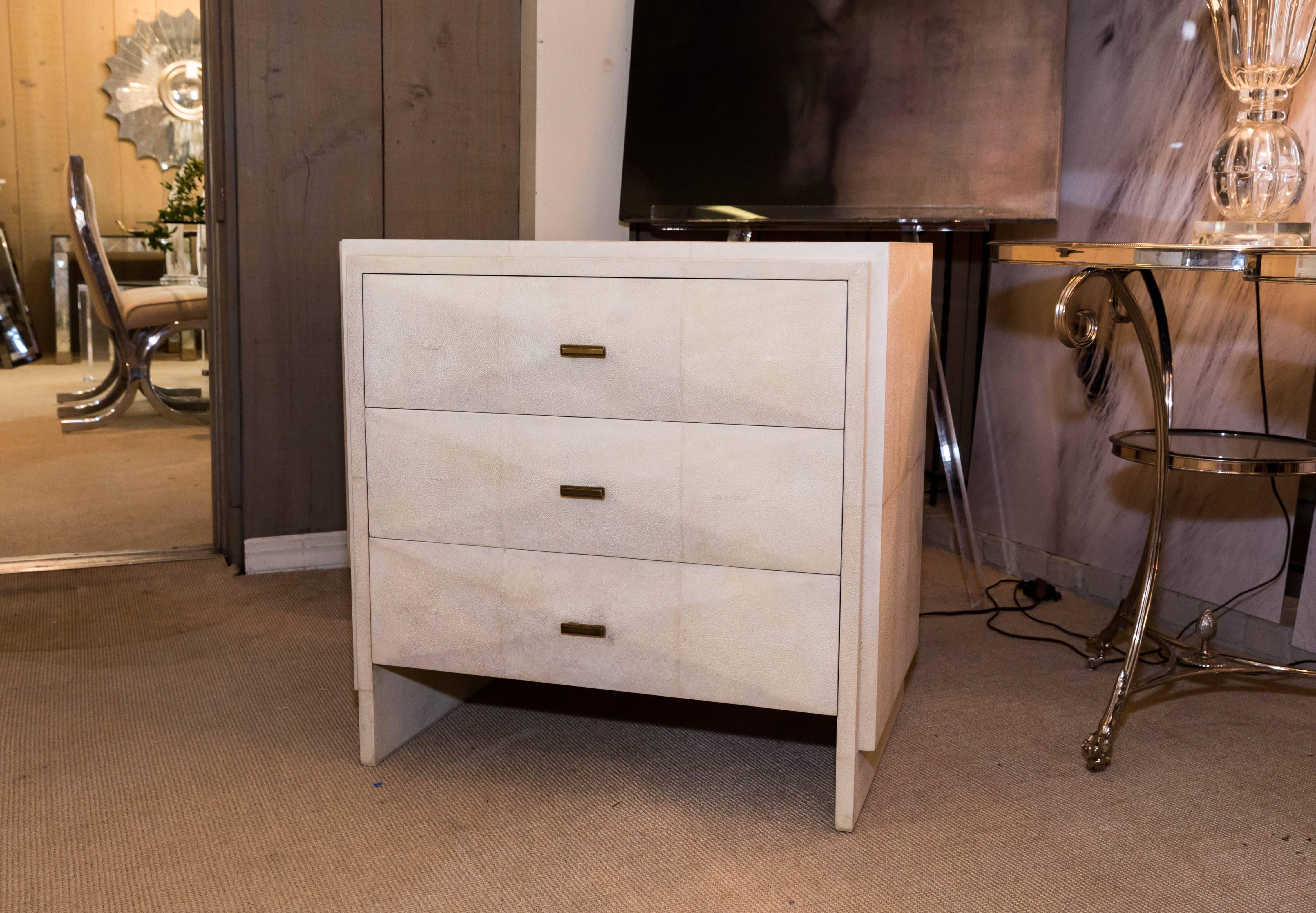 Attractive pair of white shagreen three-drawer nightstands with bronze drawer pulls.