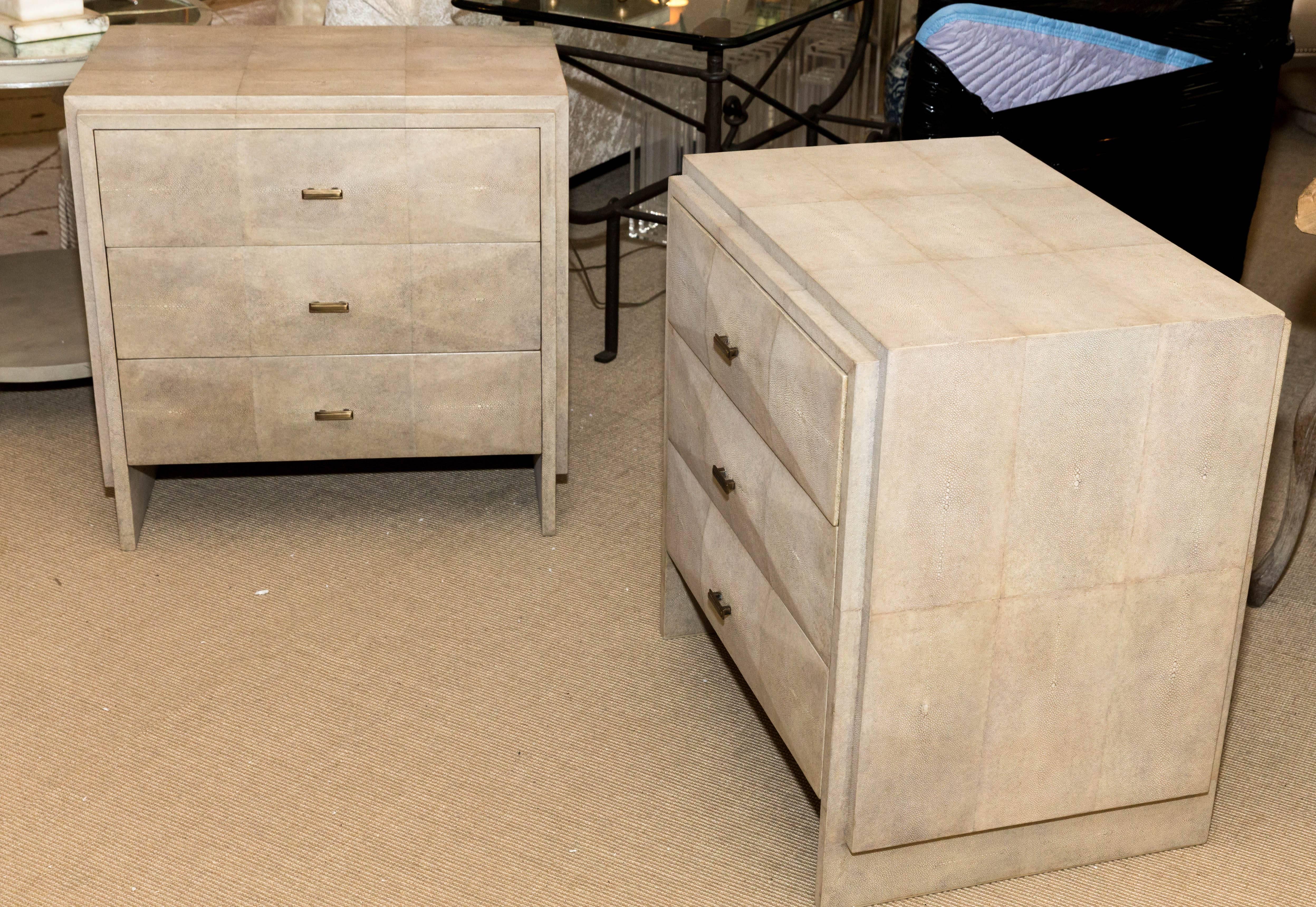 Pair of natural shagreen three-drawer nightstands with bronze drawer pulls.