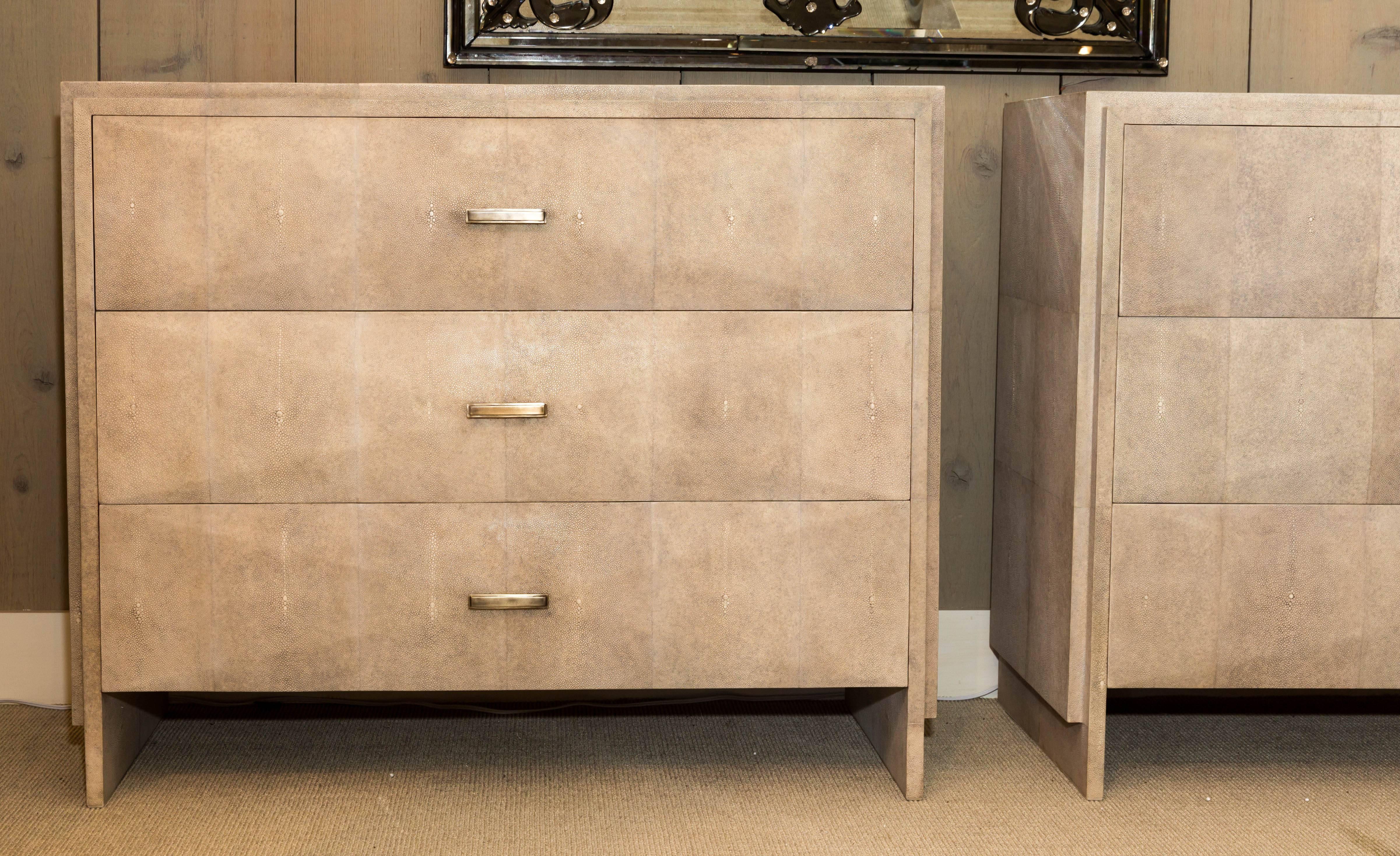 Beautiful pair of natural shagreen three-drawer commodes with bronze drawer pulls.