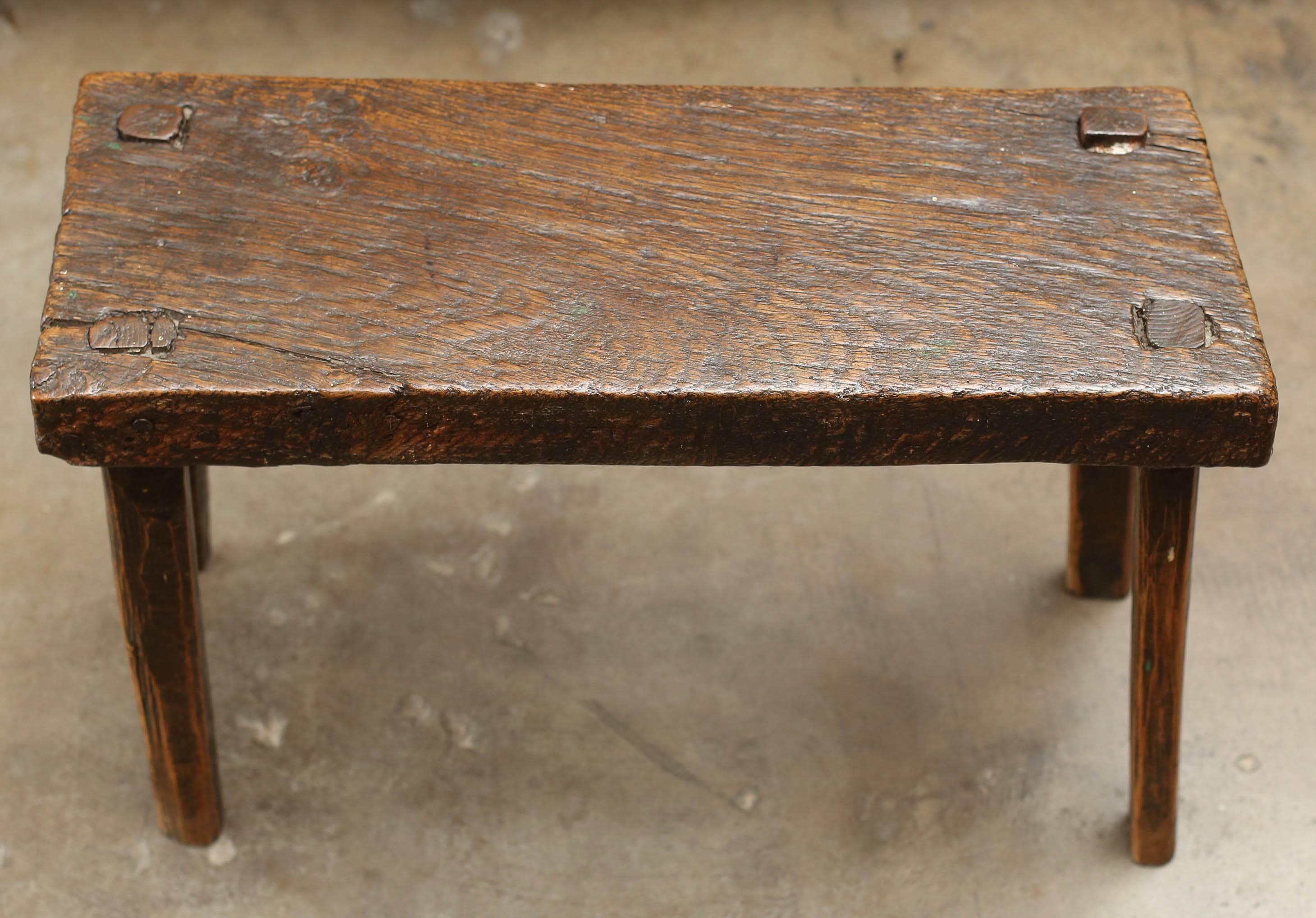 18th century rustic stool from England with thick top and straight legs. Very sturdy and beautiful patina.