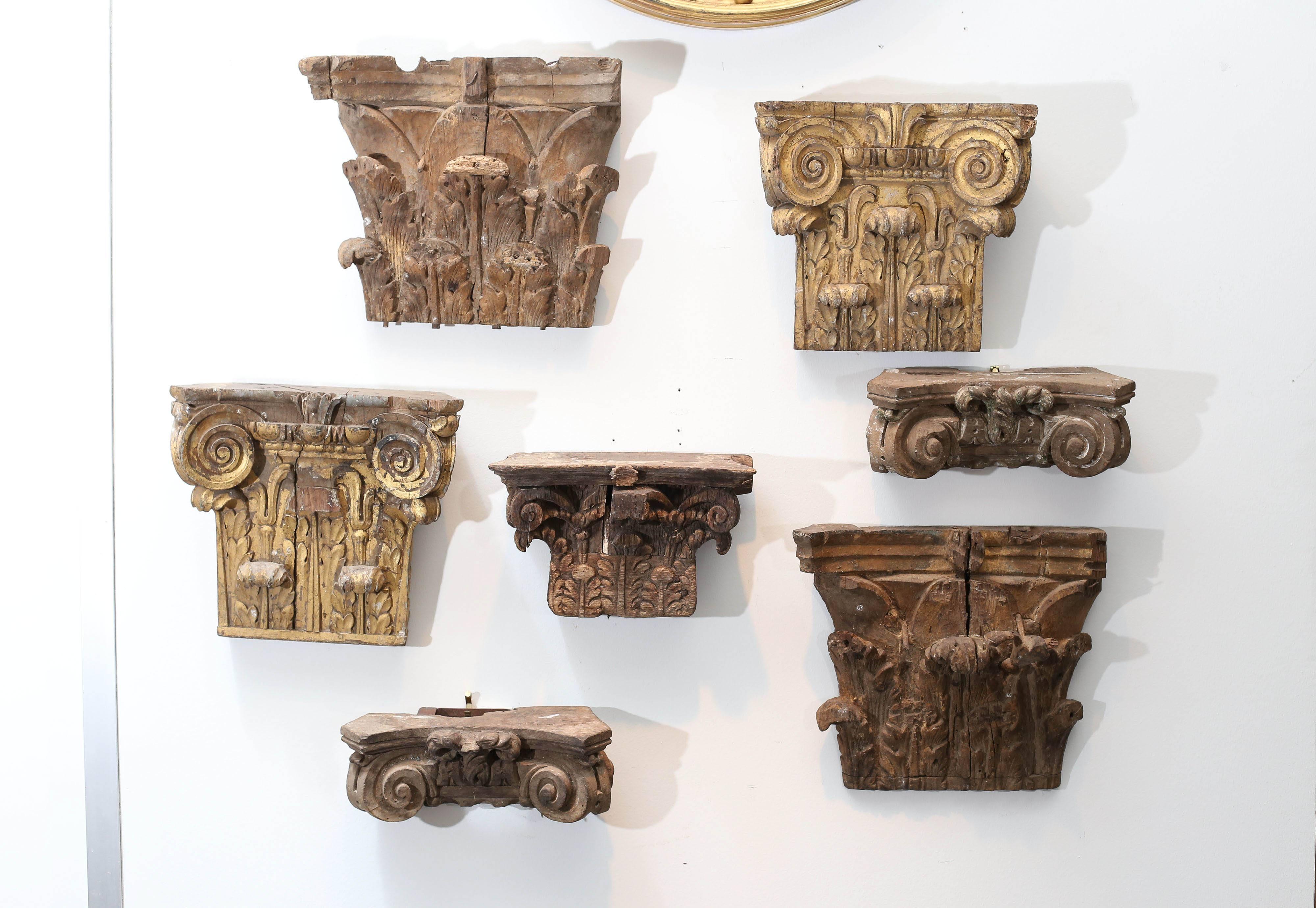 Set of seven hand-carved 18th century capitals ready for wall display. Each is beautifully carved, some with gilt details. There are three pairs and one lone one.
First pair: H 12.5