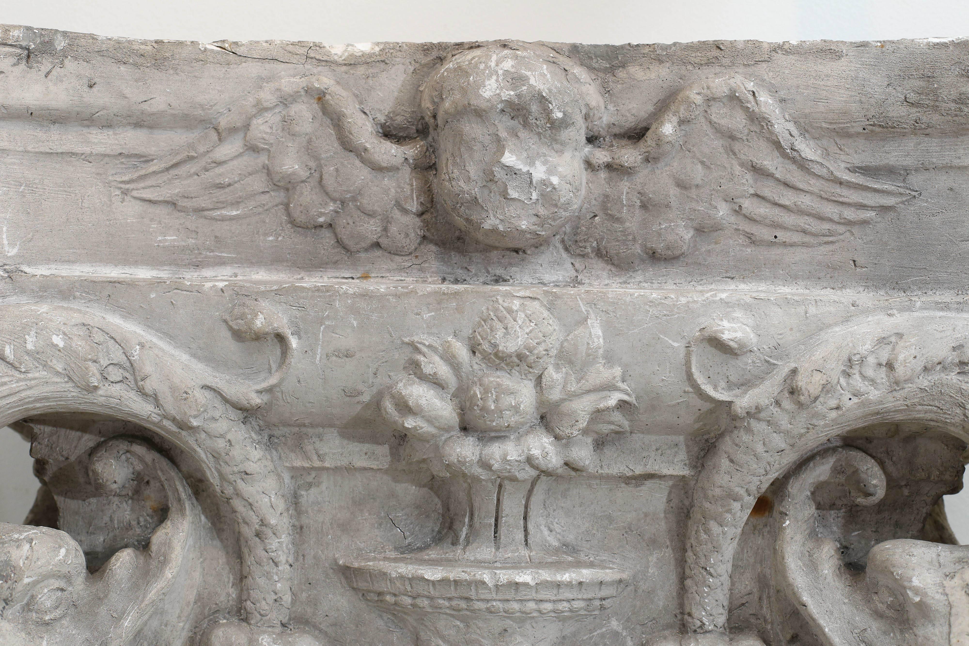 19th century plaster detail from a building in Belgium. Was the capital on top of a column which shows fish, swags, a flower and an angel. Great wall art!
  