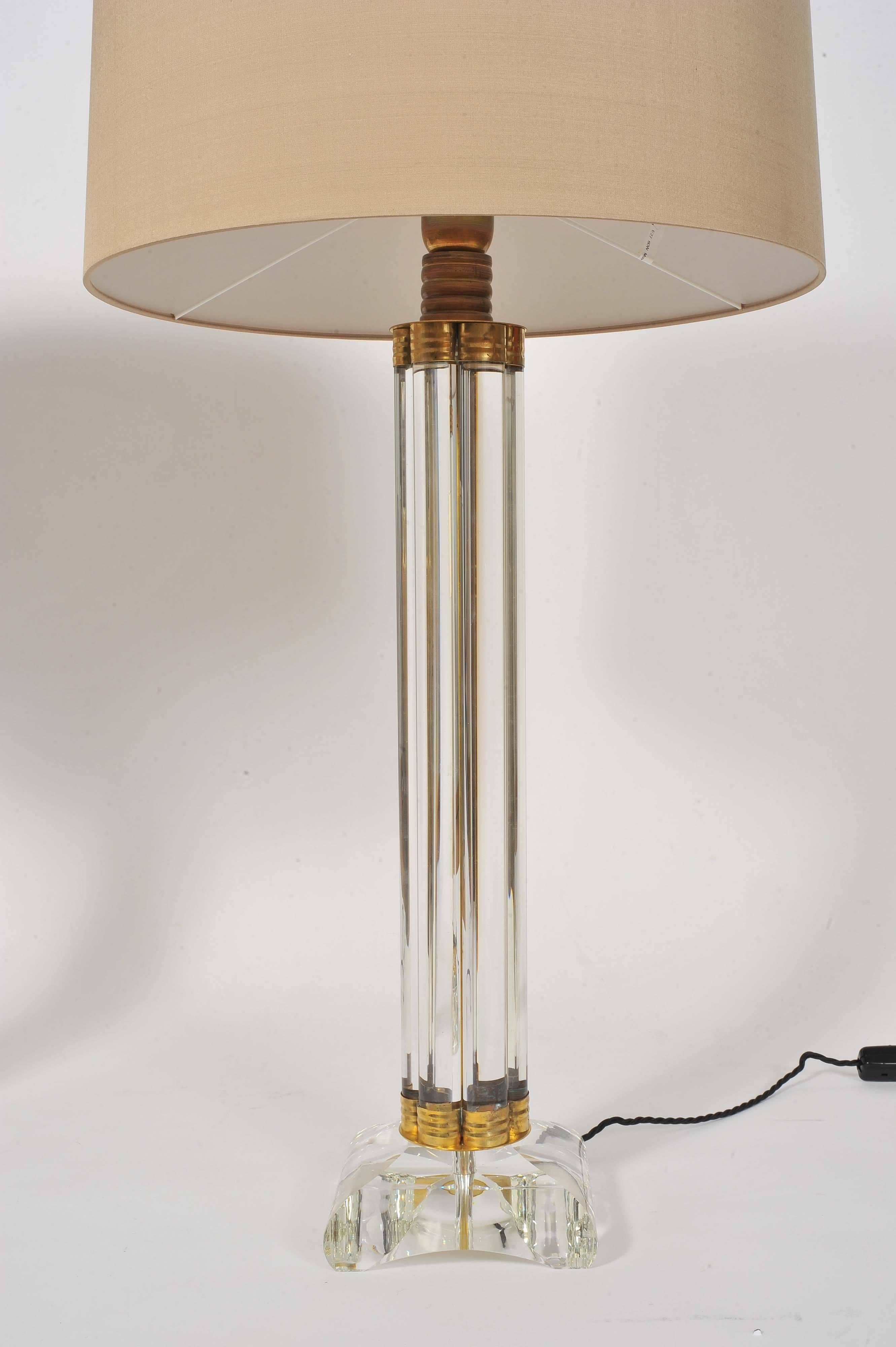 Striking pair of table lamps each made of six vertical glass rods held together at the top and bottom with decorative brass elements, standing on heavy square glass bases with rounded edges.
Height listed is without shades.