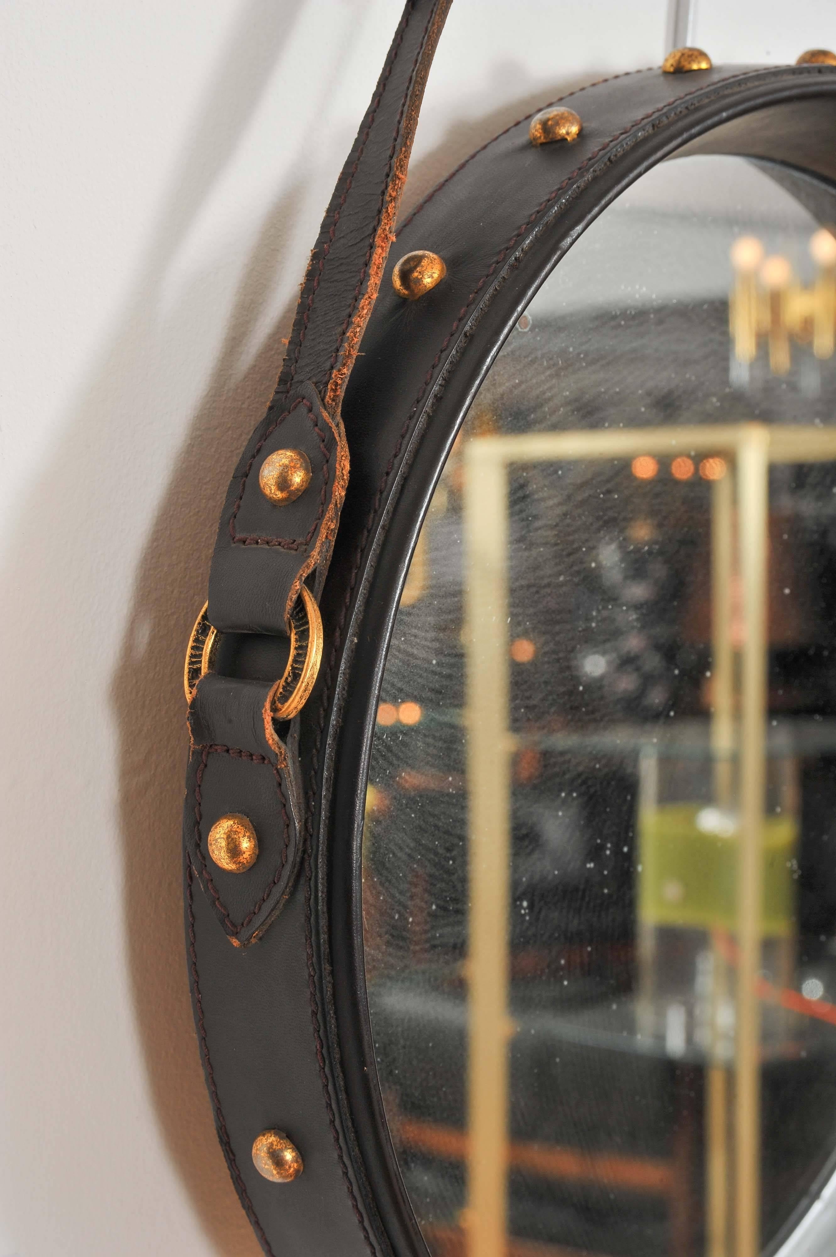 Near pair of round leather mirrors with straps
Onedark brown leather and a black leather
Style of Jacques Adnet.