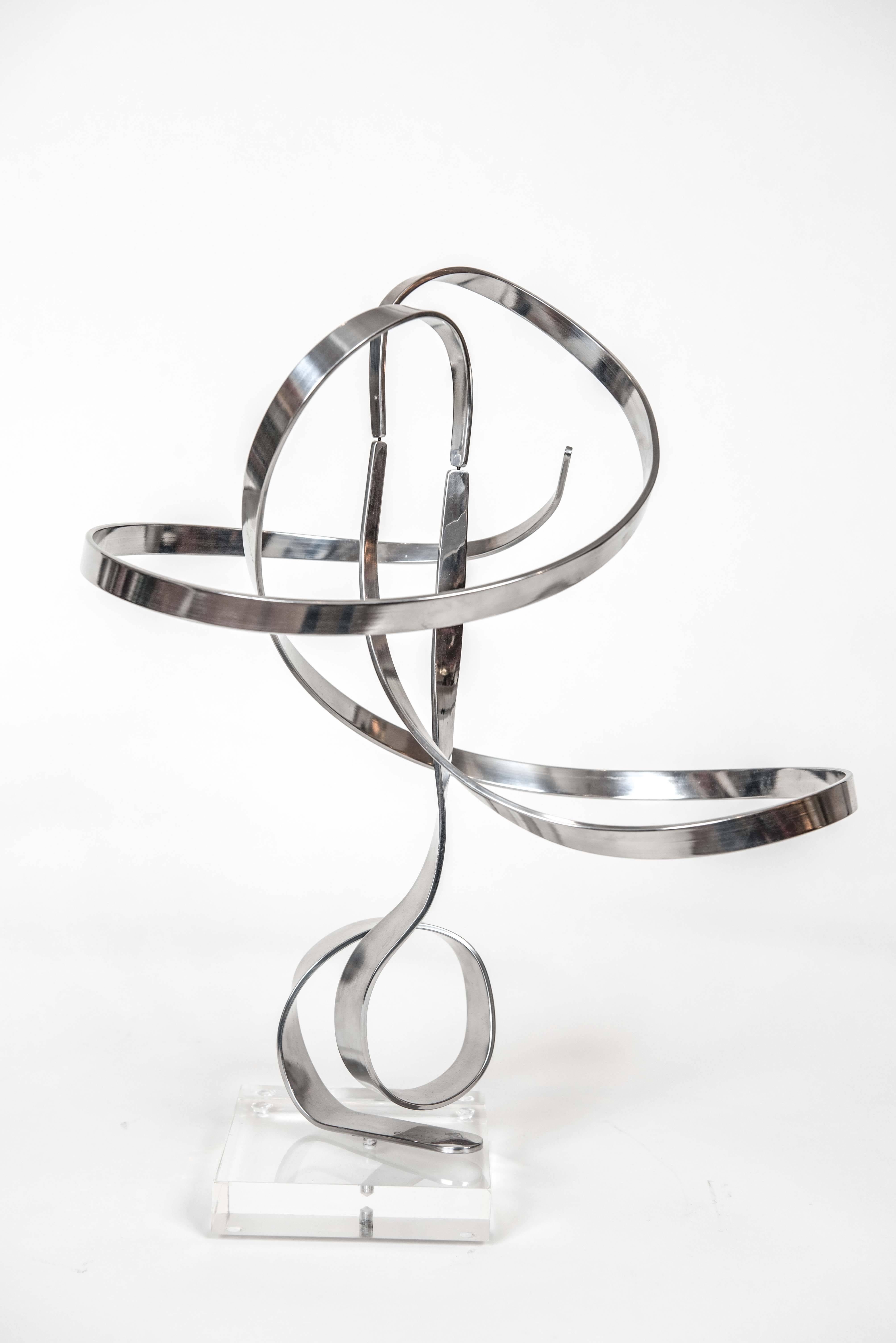 This dynamic and masterfully balanced (in two places) solid aluminum sculpture
is signed by the artist and marked with a 