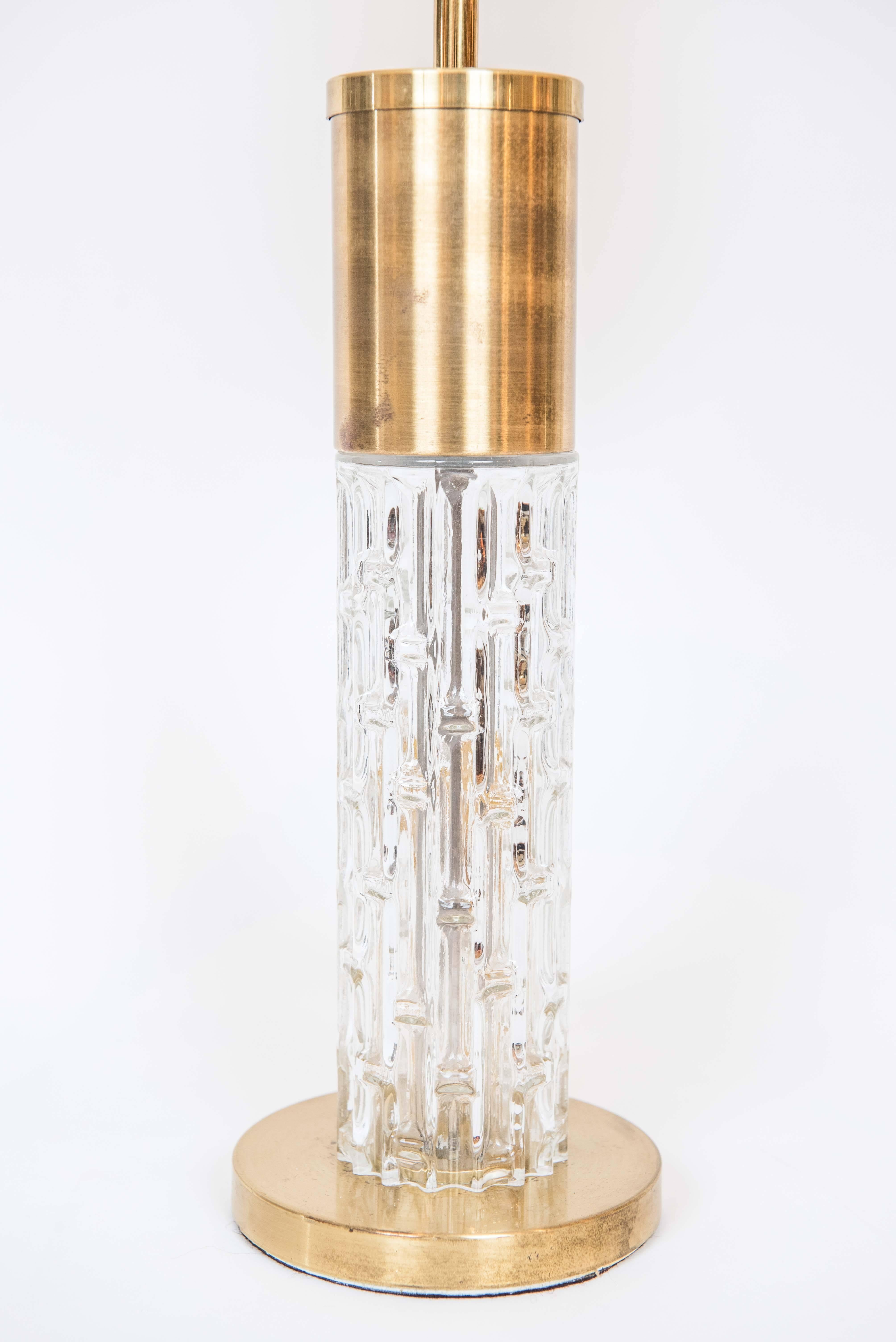 A fashionable pair of brass plated lamps with a stylish molded glass column.
The lamps have been updated with new sockets, wire, and shades.
Shades are optional. Overall height to the top of the shade is 27