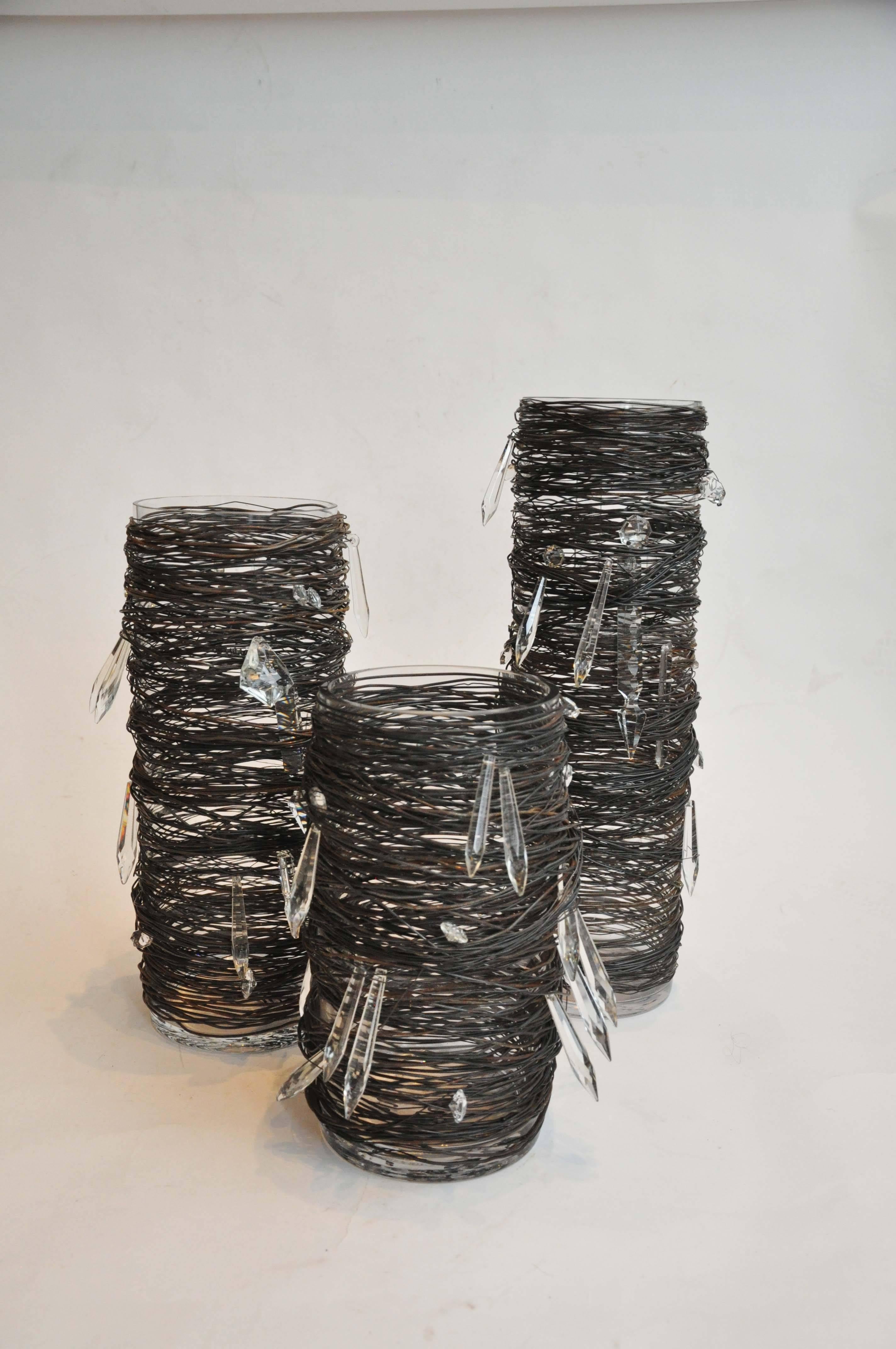 21st century wire and crystal vessels by sculptor Lucy Slivinski. 
Each glass vessel is wrapped in layers of metal and a cut glass crystals interwoven into the metal layers. 
Fabulous as a vase or as stand alone sculptures. 
Priced per piece
Three