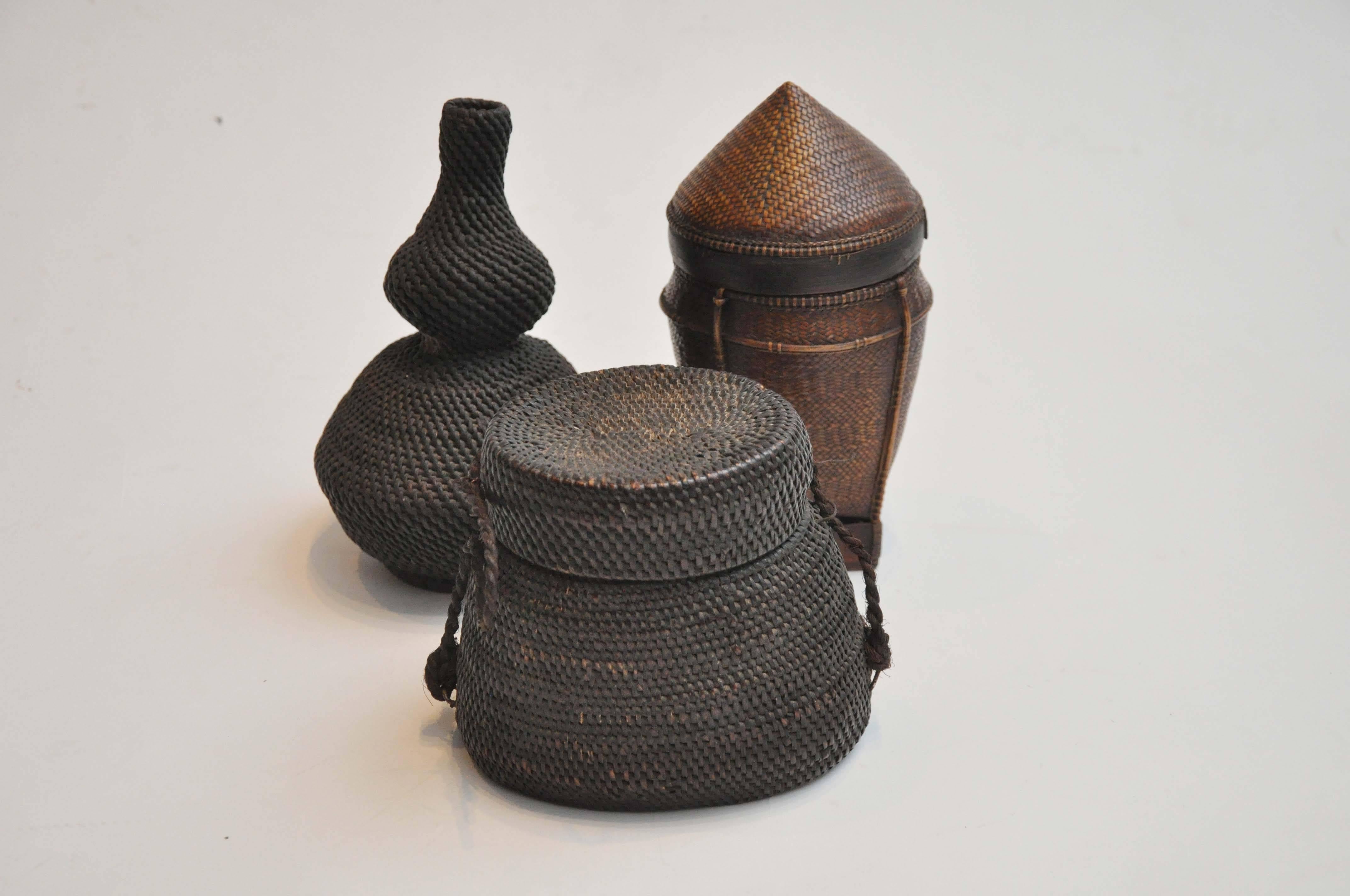 19th century  Asian basket trio.
Handwoven Thai vessel, circa 1880.
Dimension: 7.75"H x 4.5"DIA.

Antique Philippines lidded basket, circa 1800s.
Dimension: 5.5"H x 5"W x 4.5"D.

Small Philippines basket with pointed Lid,