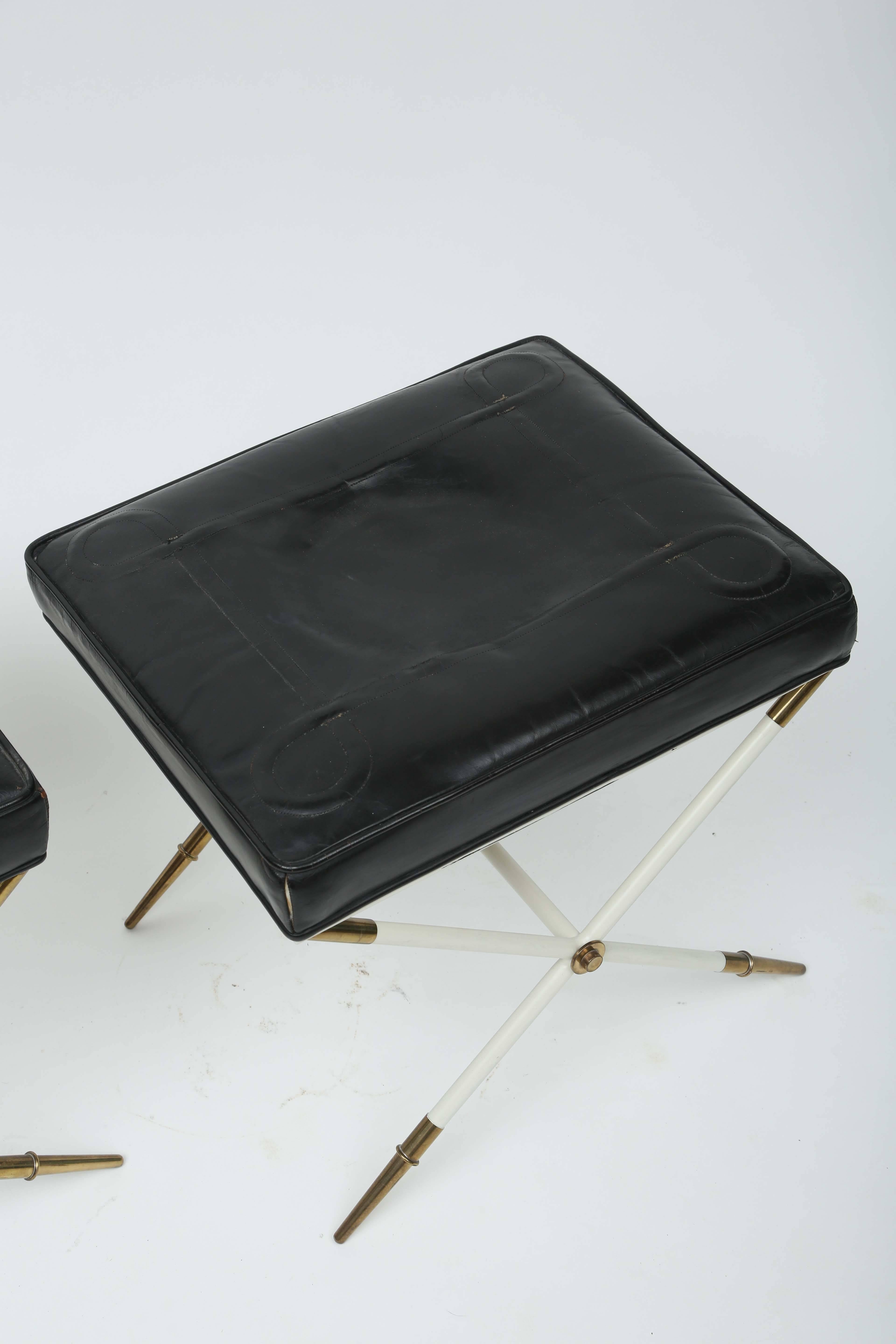 An extremely rare pair of stools with their original embossed leather 
cushions and lacquered legs.