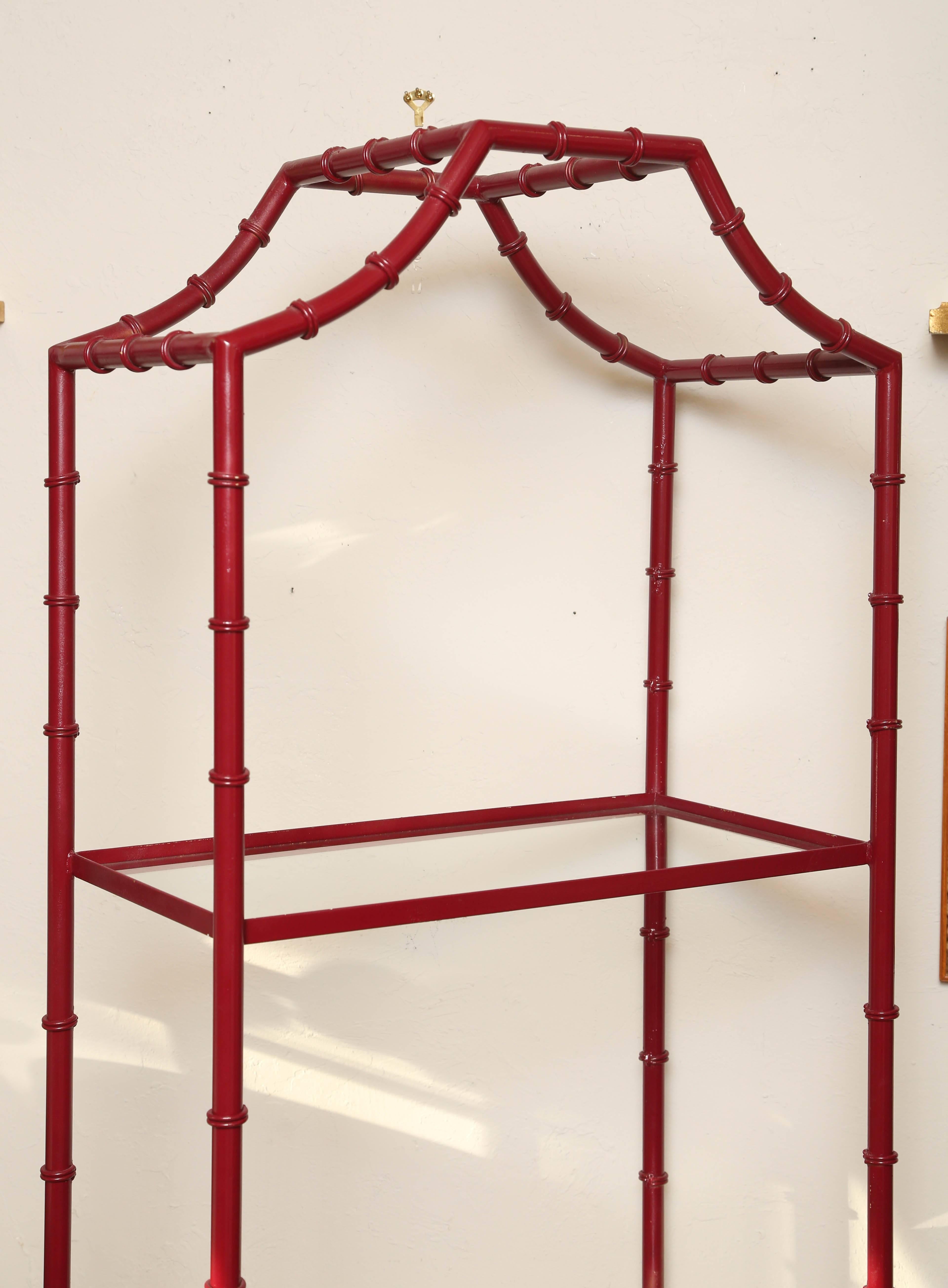 Lovely pair of Chinese red faux bamboo étagères with three glass shelves.