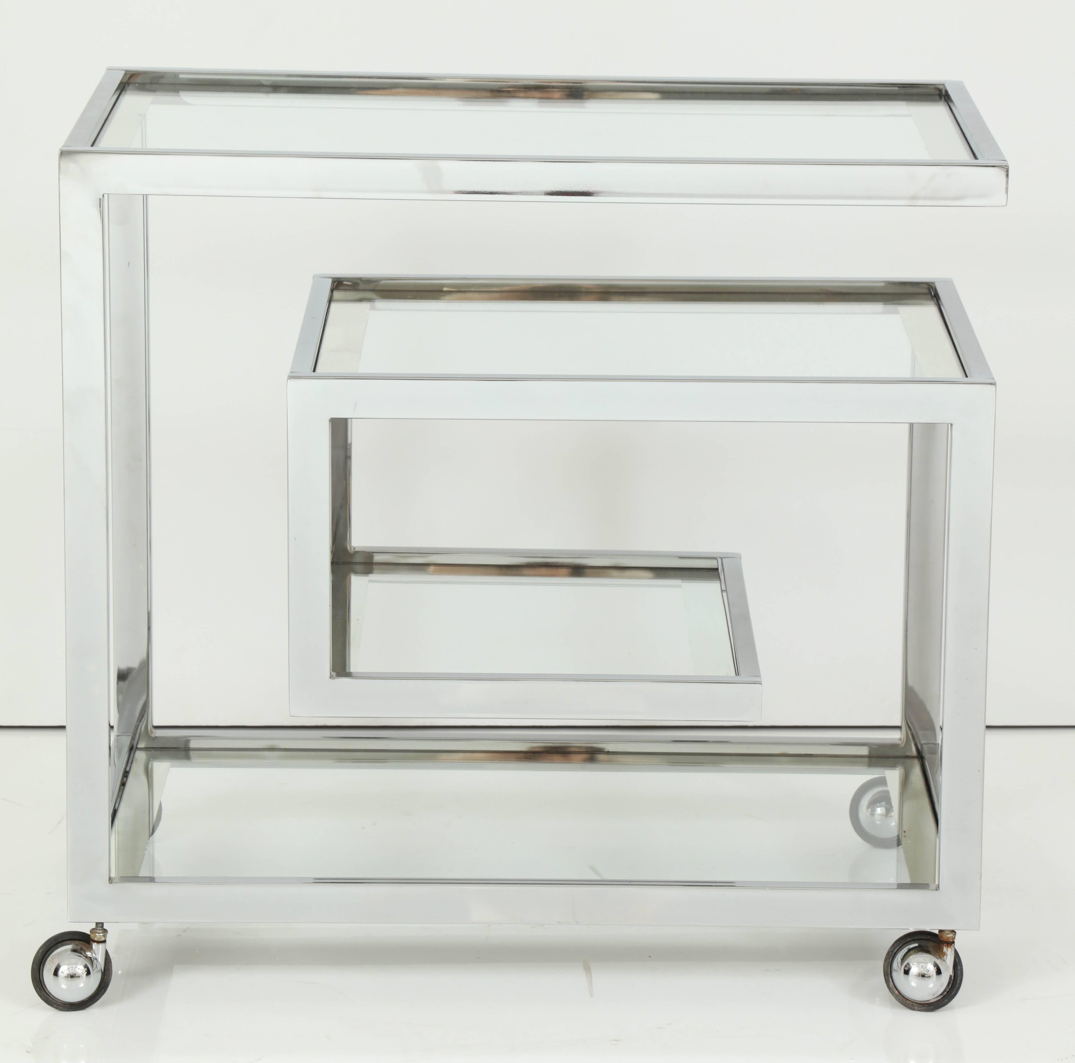 Decorative chrome bar cart, circa 1960, Italy. Beautiful glass shelves with silver borders. Bar cart is on wheels.