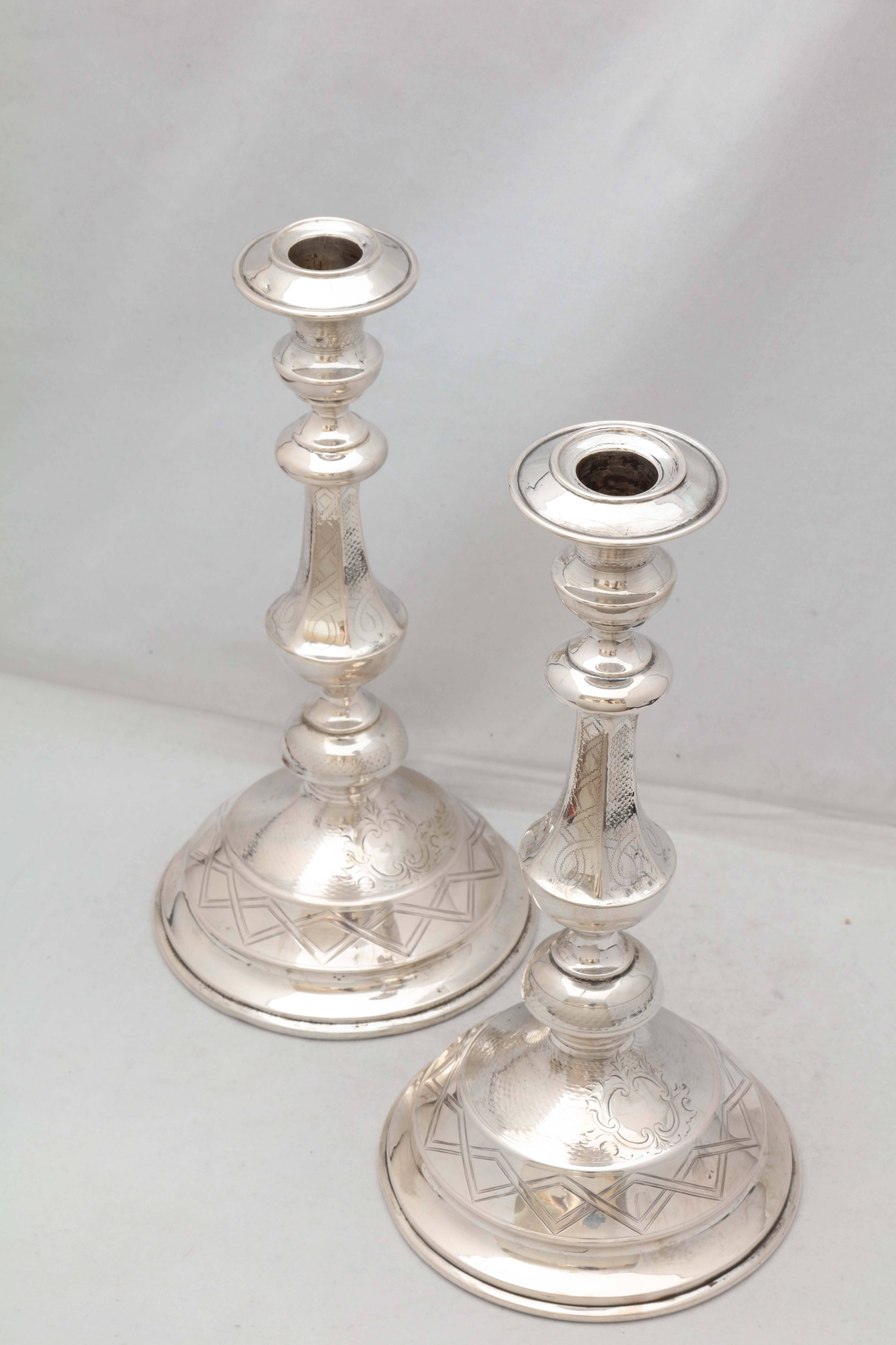 Pair of Continental silver (.800) Sabbath candlesticks, Austria, circa 1870. Each candlestick measures: 10 1/4 inches high x 5 1/4 inches diameter across its  base. Unweighted - total weight for the pair is 13.365 troy ounces. Dark areas on silver 