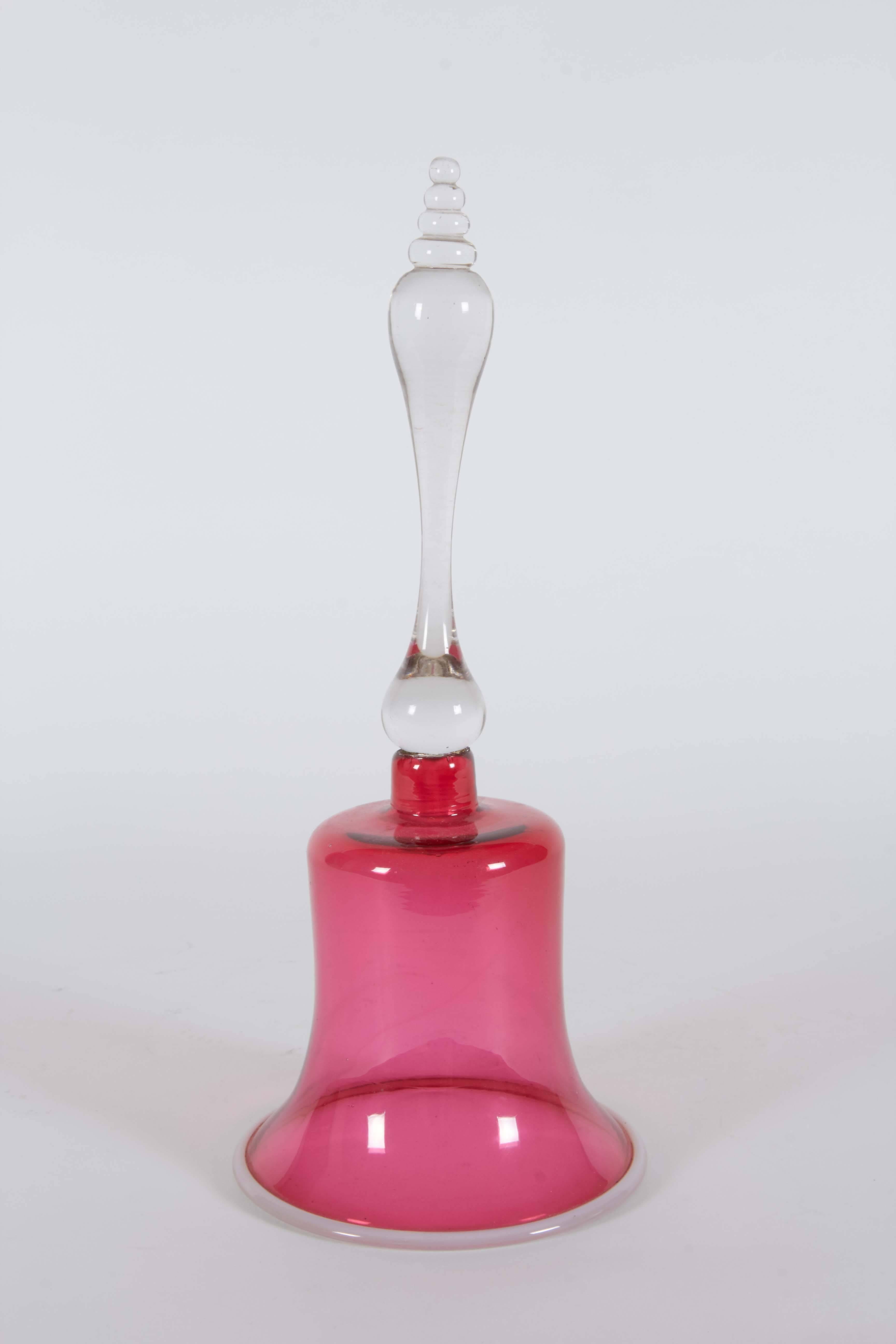 This beautiful glass bell is from the 1880s in England. The glass is finely crafted with subtle details. The cranberry color adds a touch of color into any living or entertaining space.