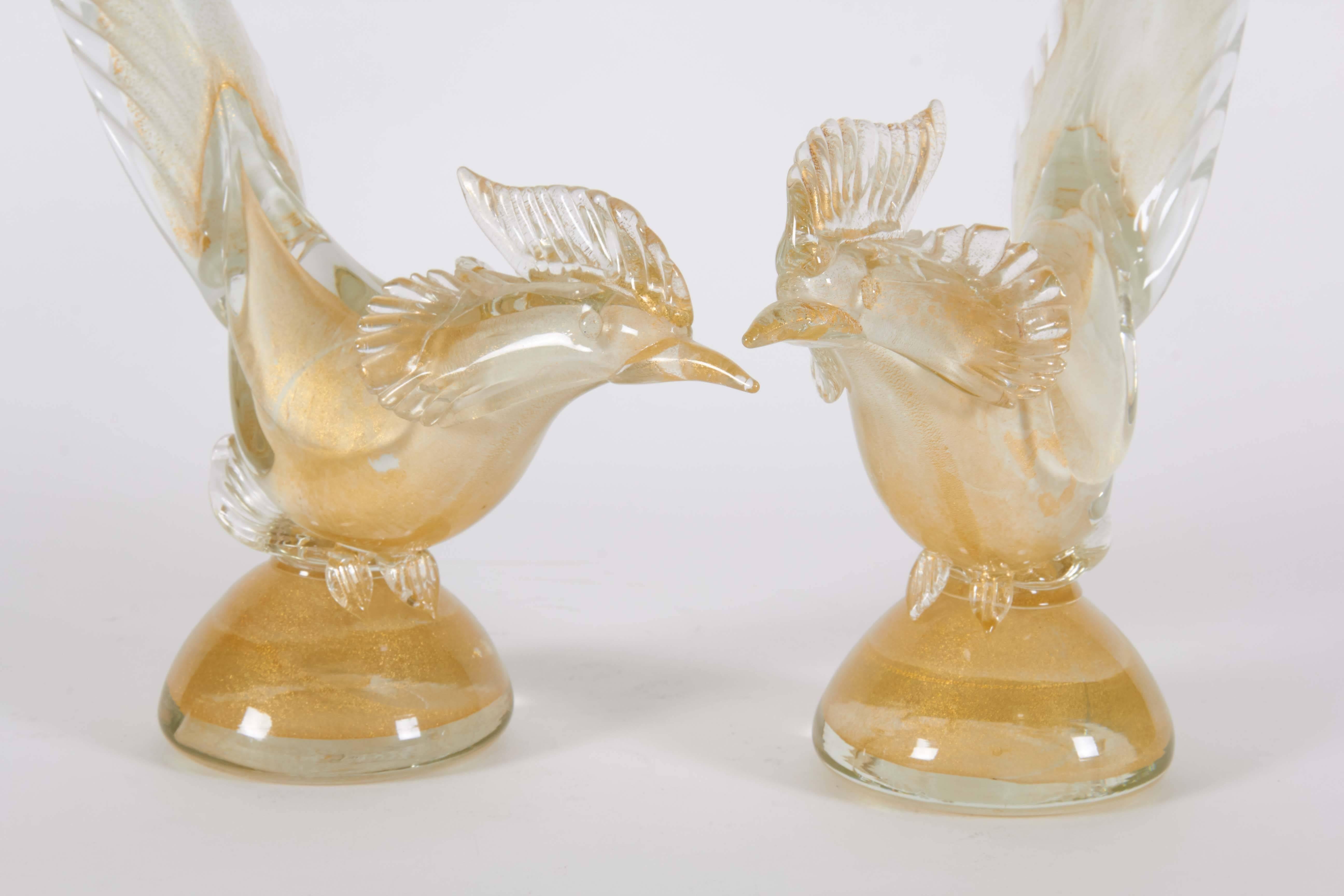 This pair of vintage gold and glass Seguso Murano roosters with their tapering long glass tails are an elegant home decoration. The roosters have beautiful detail showcasing the Murano craftsmanship.