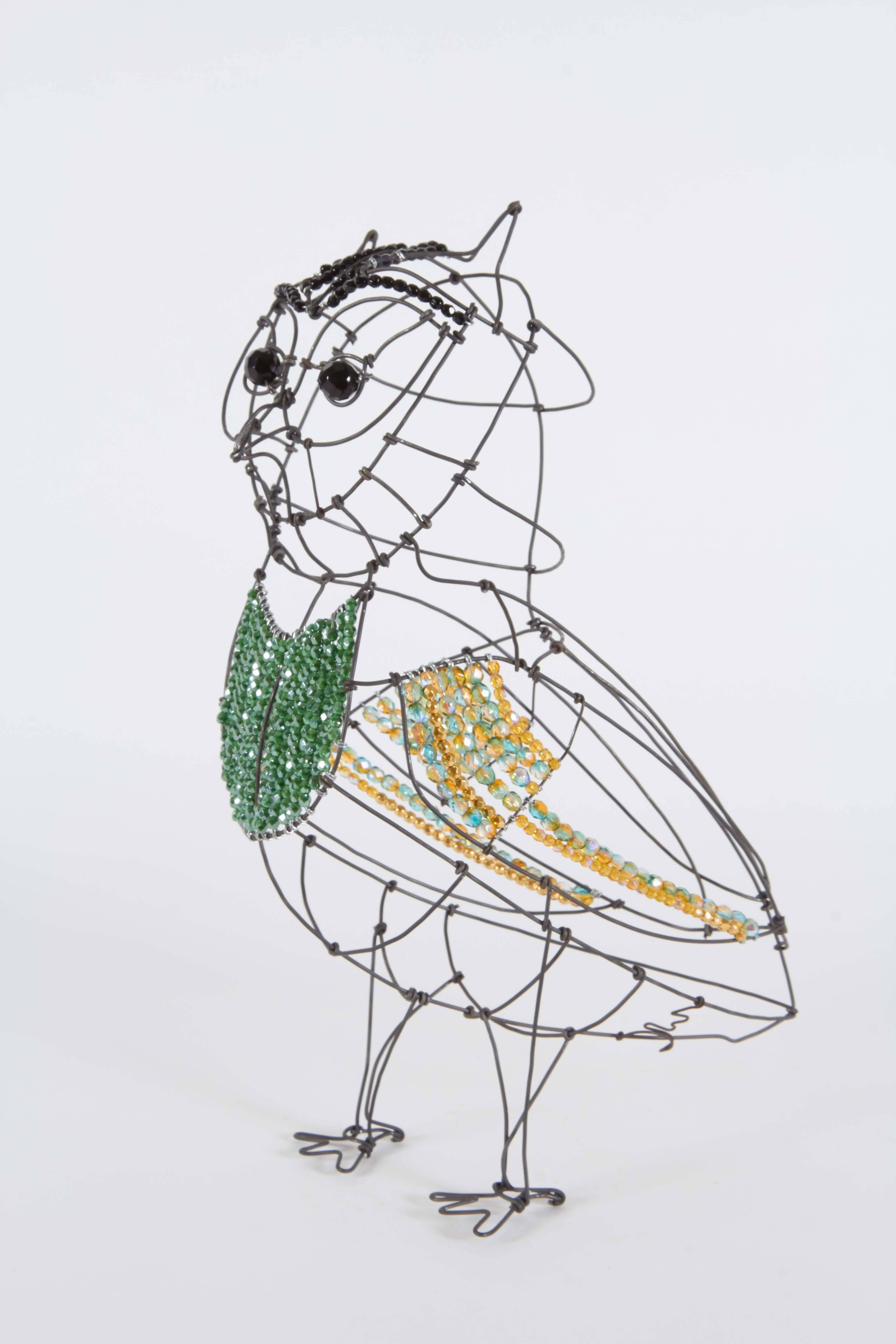 Marie Christophe designs whimsical wirework figurines. They are as light as air and as transparent as bubbles in a champagne glass. Marie’s sculptures of wire and beads are objects of beauty and centerpieces of any space they find their home. Marie