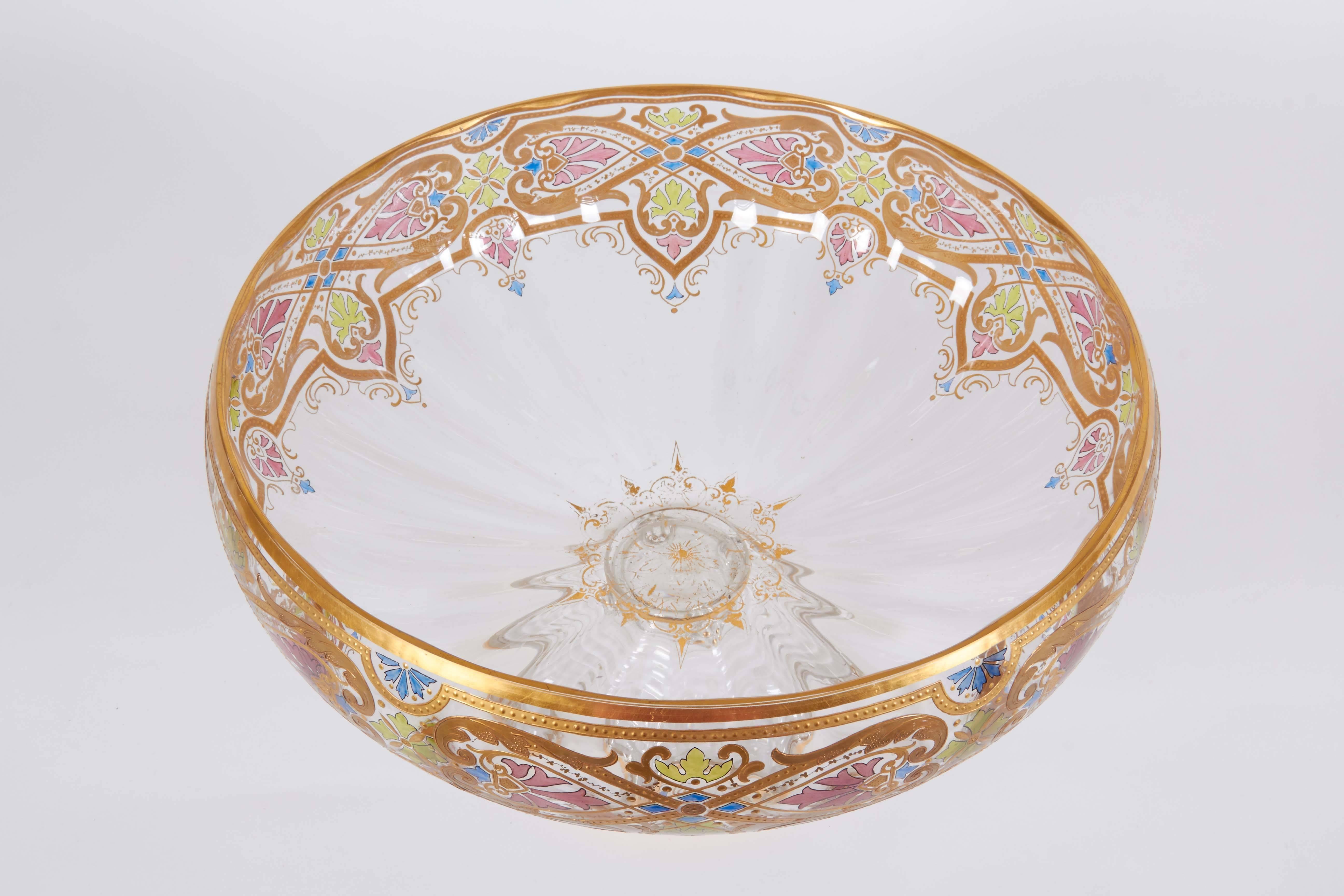 A large and impressive Art Nouveau centerpiece punch bowl set with blown glass under tray and 11 punch cups, raised gilt and enamel painted design.

Measures: Bowl: 13