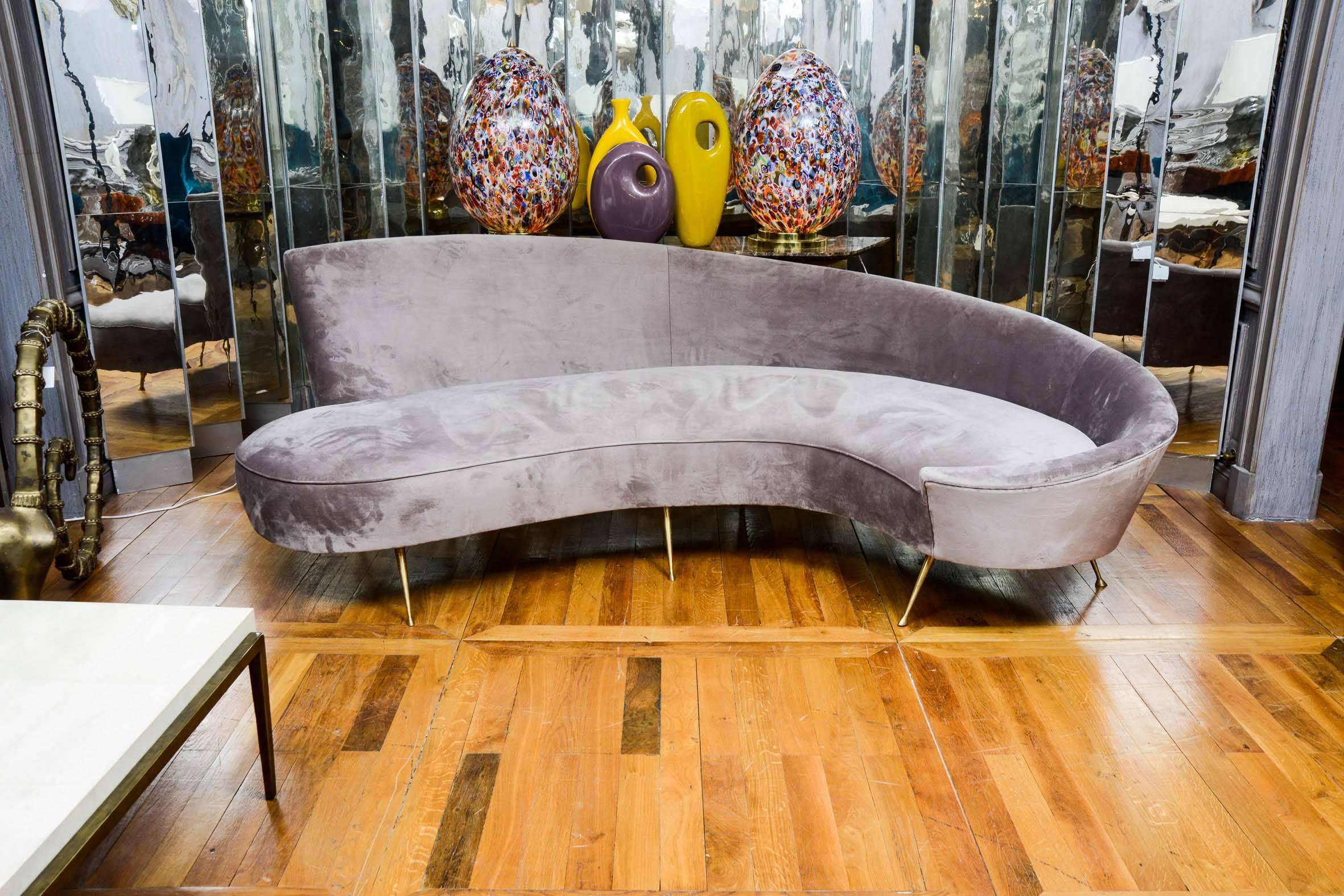 Vintage sofa, curved shape, newly upholstered with grey velvet, brass legs.