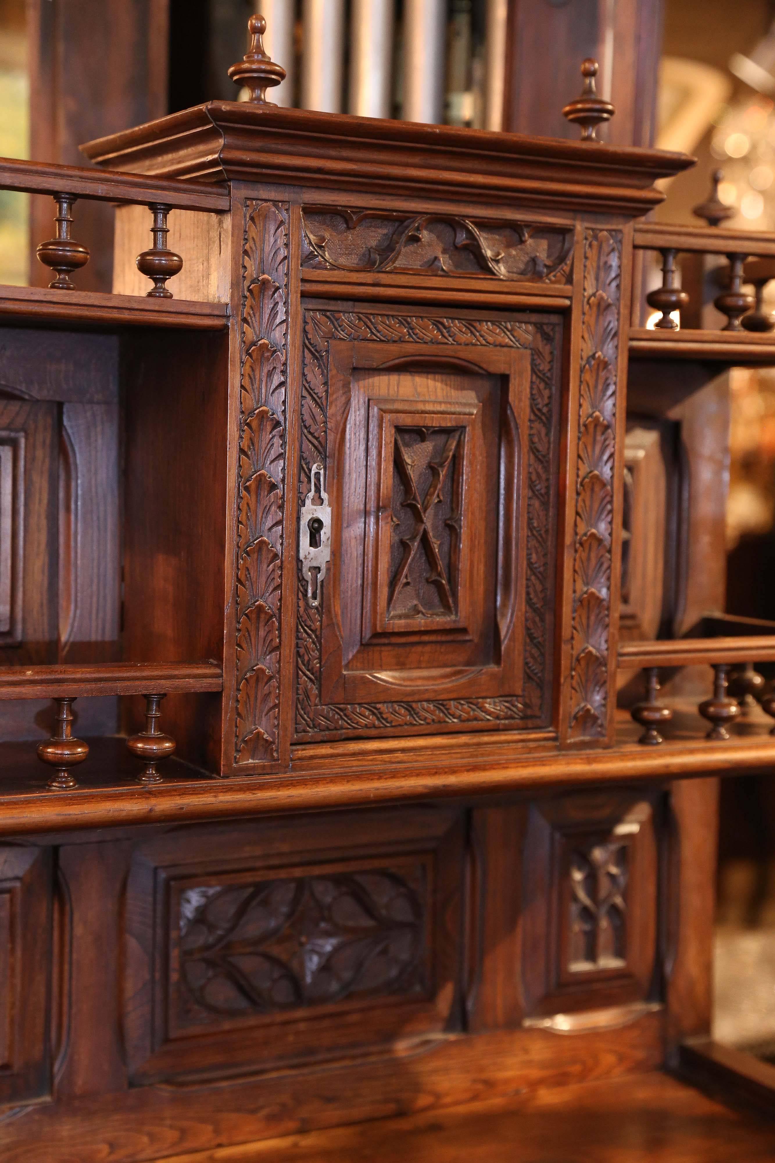 French cabinet made of walnut with lovely carving.
It has an upper structure with a petite door.
It has one drawer and has two lower doors. 
It has barley twist posts that are beautifully constructed.
Carved doors and leaf like carvings adorn
