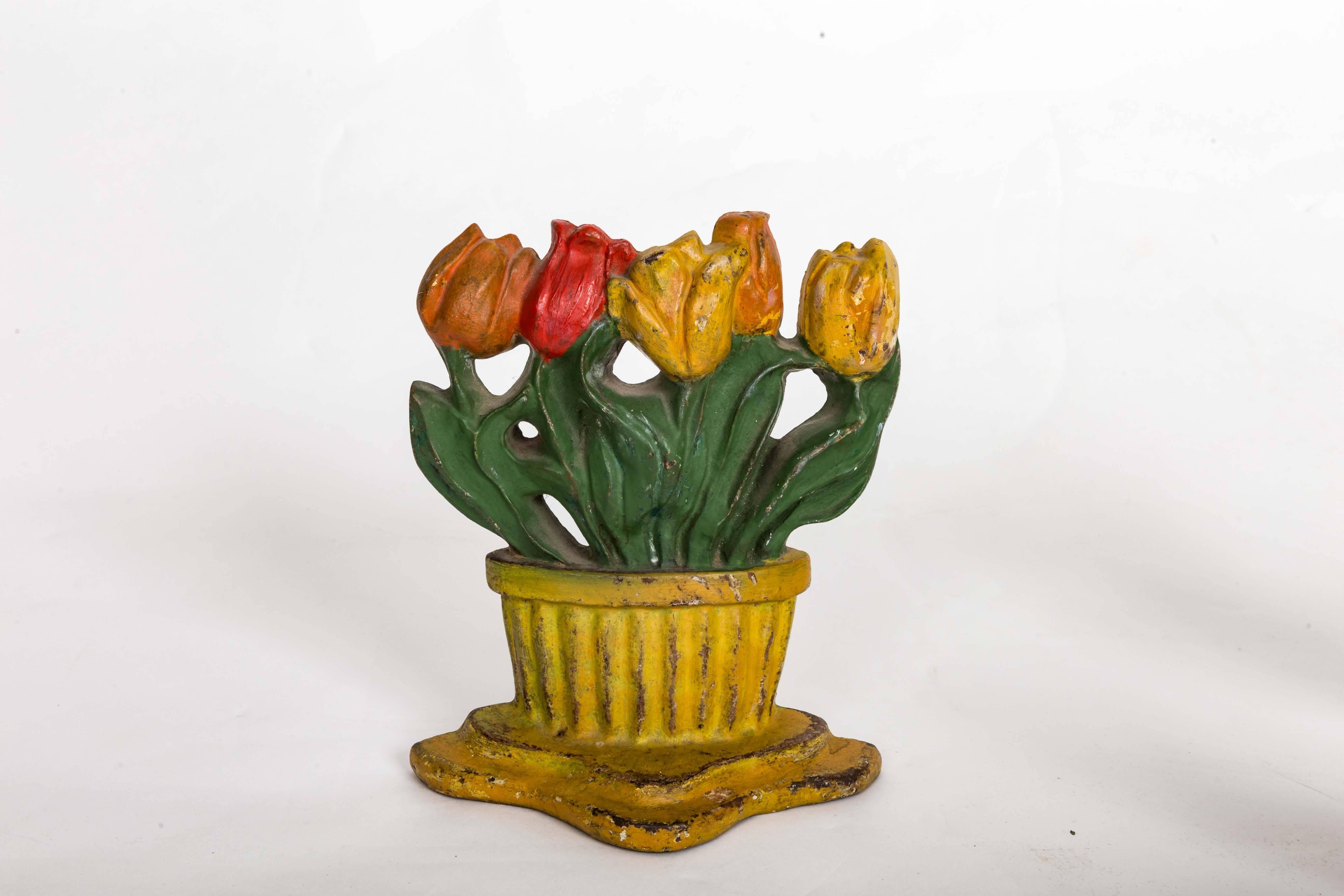 Group of five early 20th century painted cast iron door stops. (Tulips in Yellow Basket Sold)


