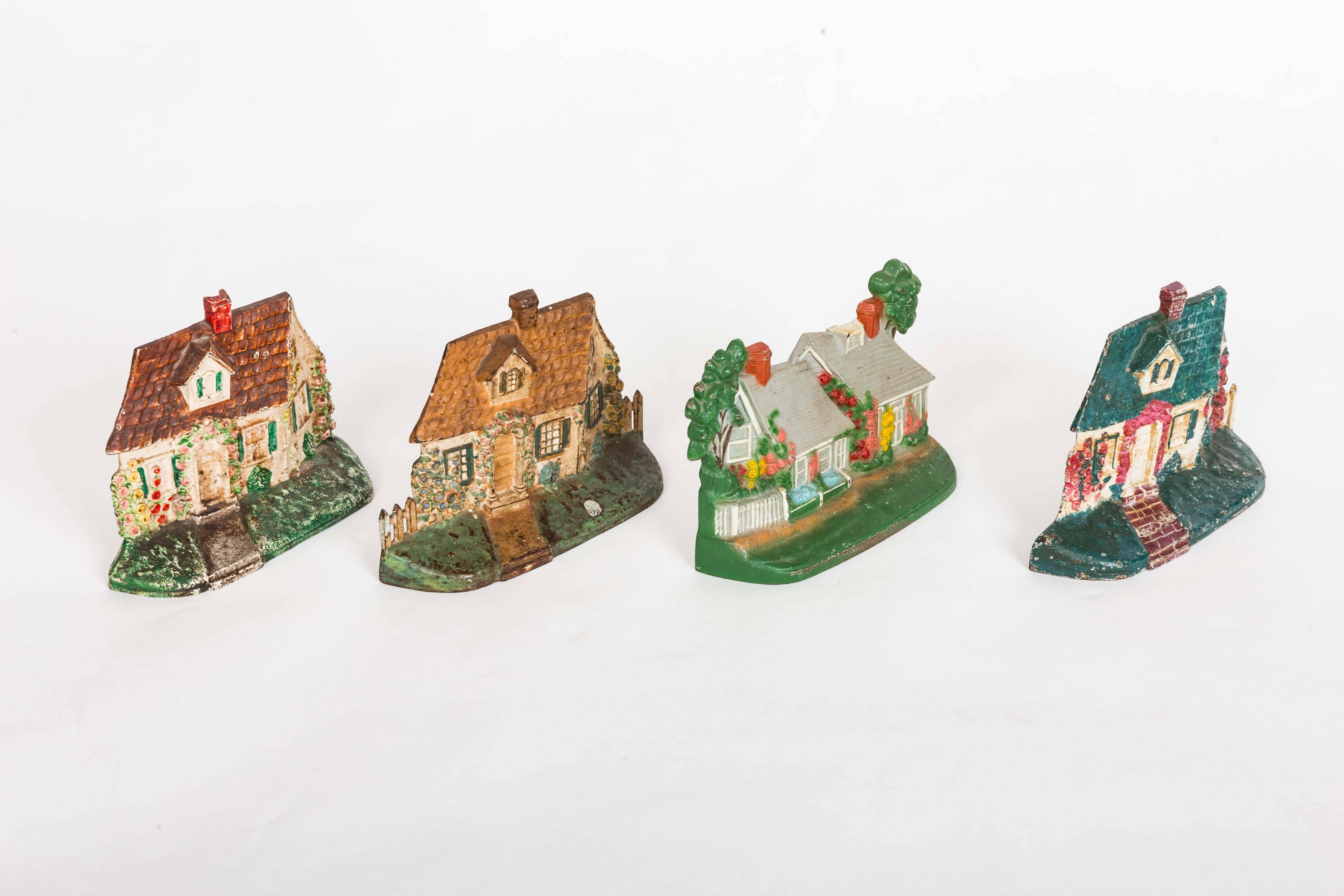 Folk Art Group of Four Painted Cast Iron Doorstops For Sale