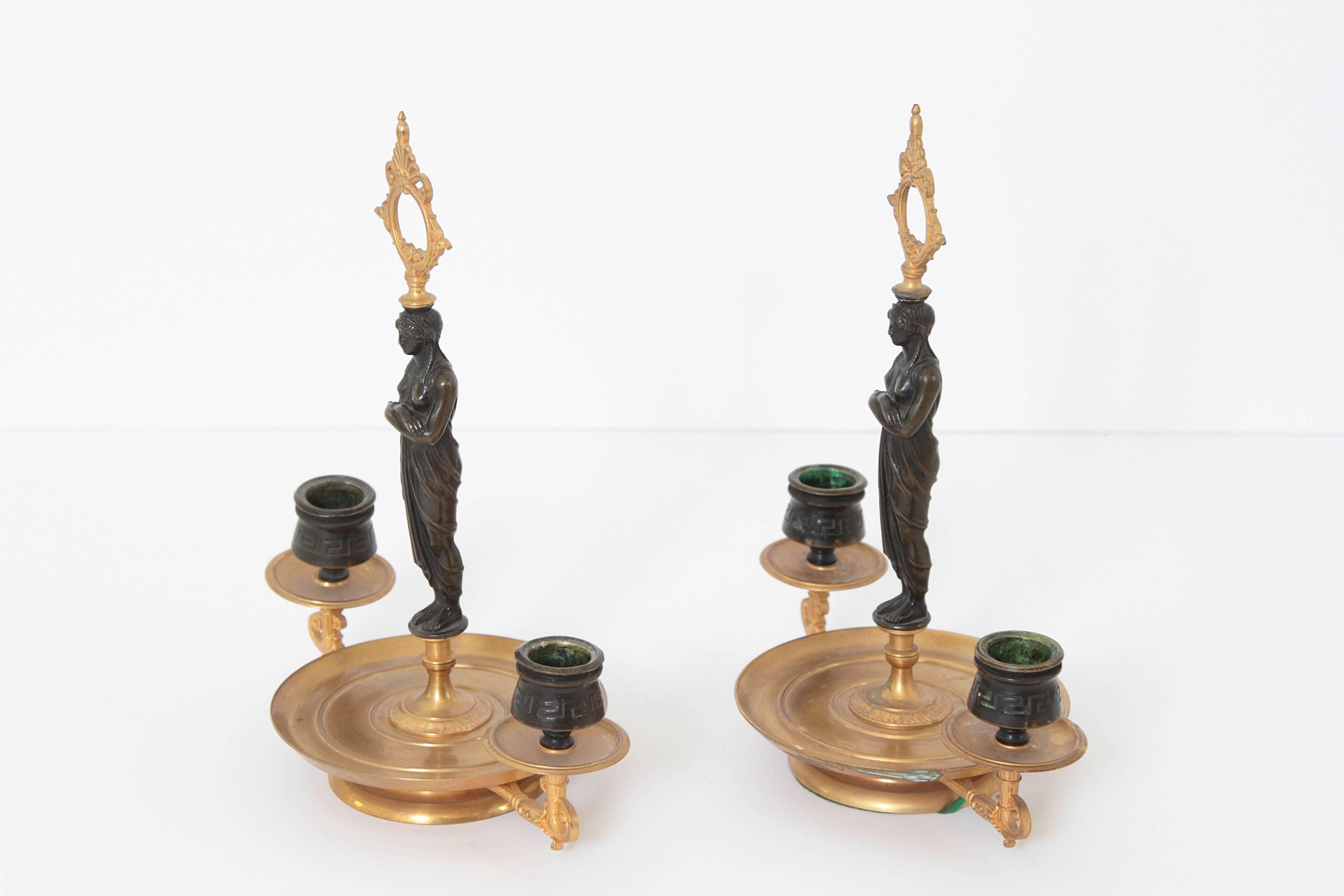 19th century candelabra. Patinated bronze figures centre the pieces. 

 

 