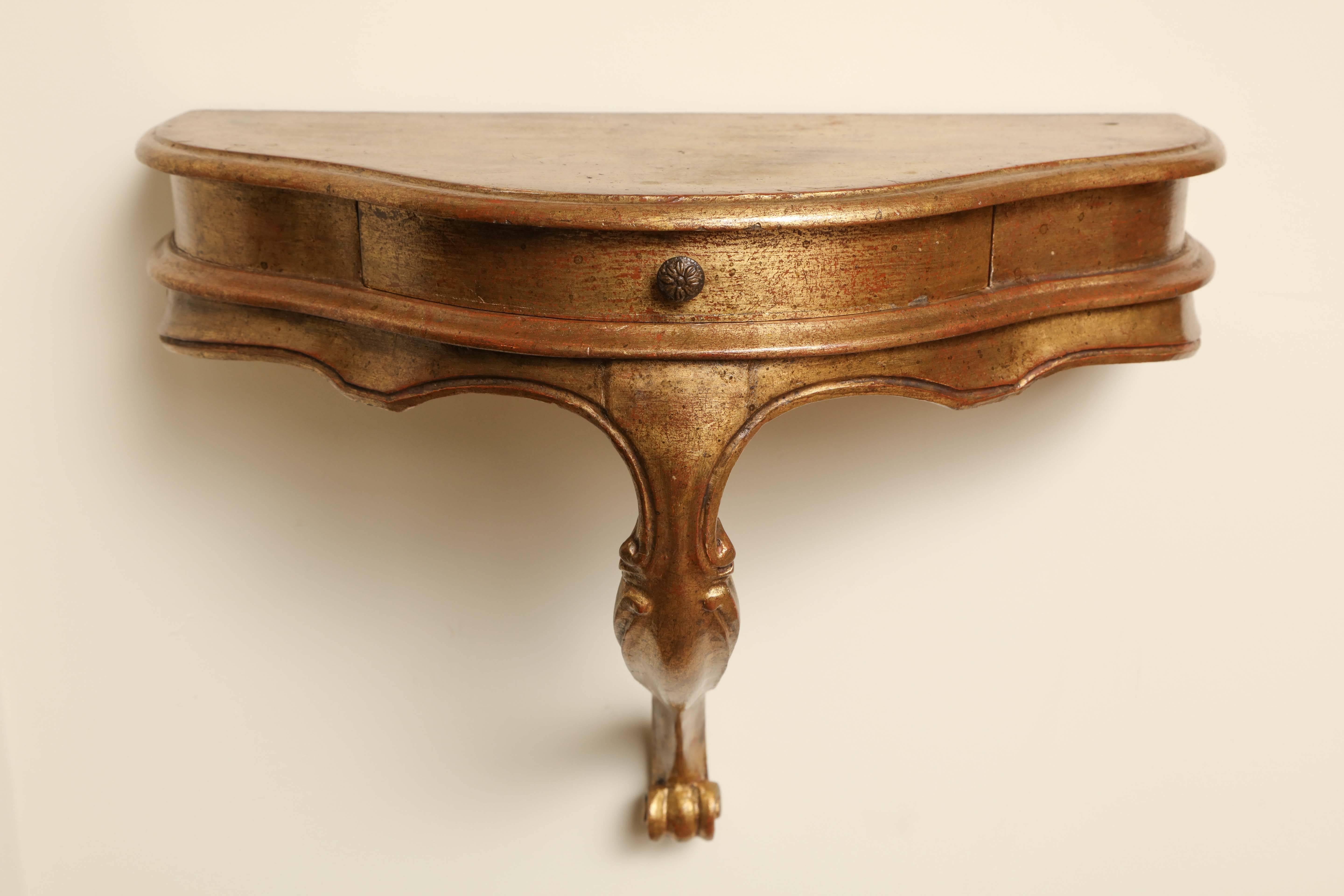 Italianate wall-mounted console with gilded surface, circa 1940.