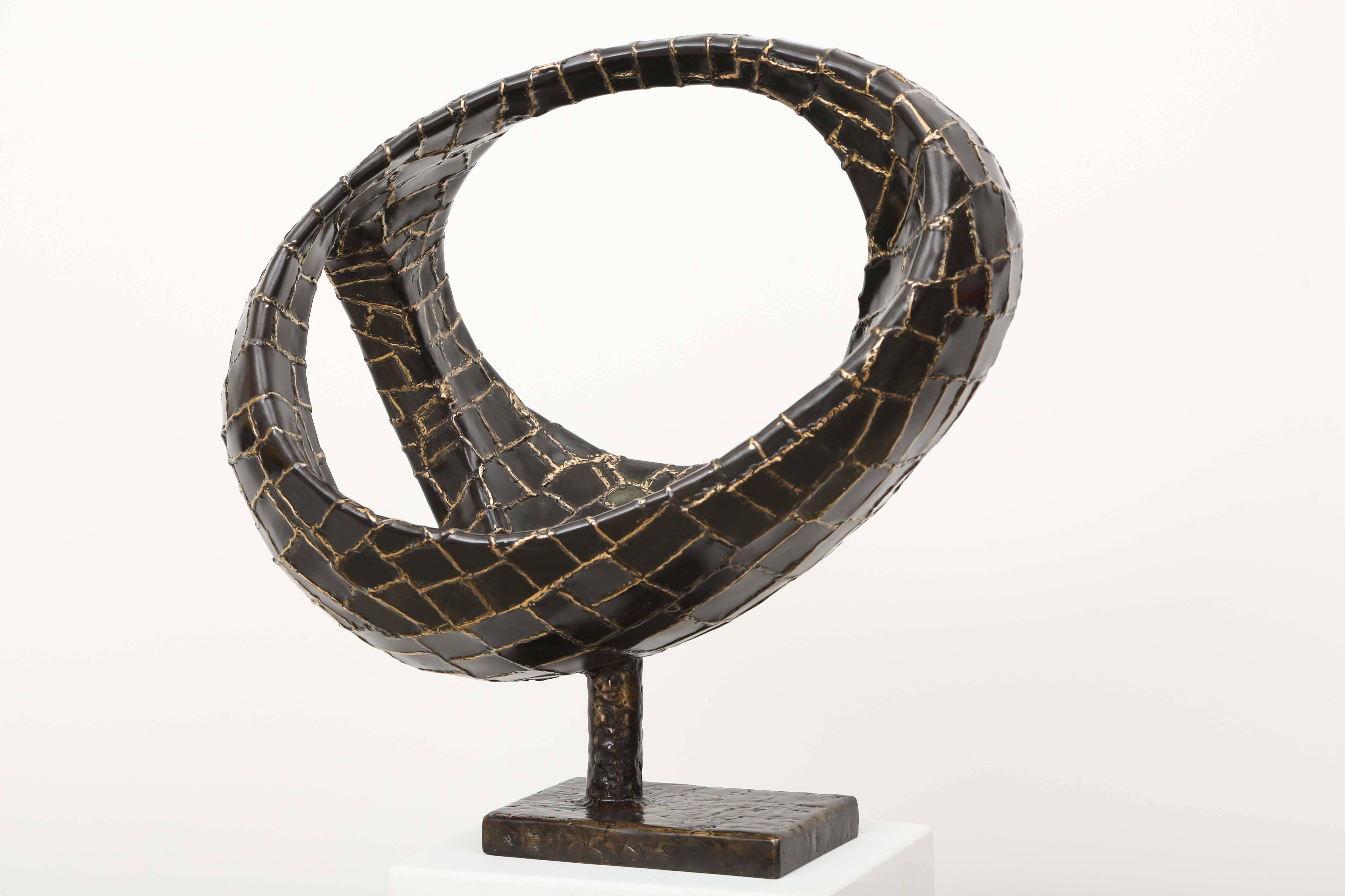 Abstract sphere sculpture made of bronze with three oval openings.
by the French well know sculptor Jacques Duval-Brasseur.
A 