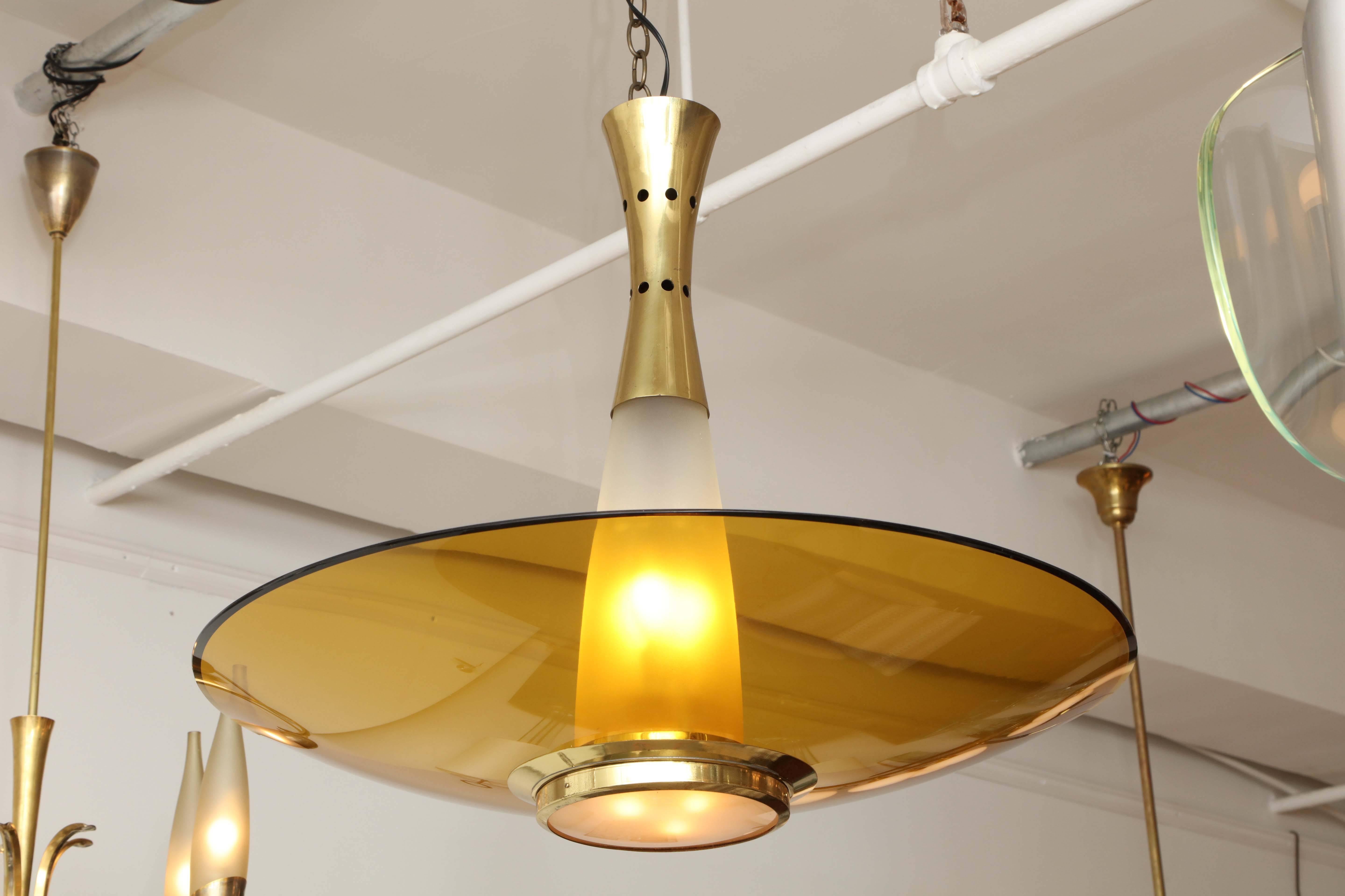 Modernist large chandelier made in Milan1955 by Fontana Arte designed by Max Ingrand. Amber curved glass shade with a bevelled polished edge, above is a frosted conical glass shade with a brass collar, great quality, takes six e14 bulbs.
 