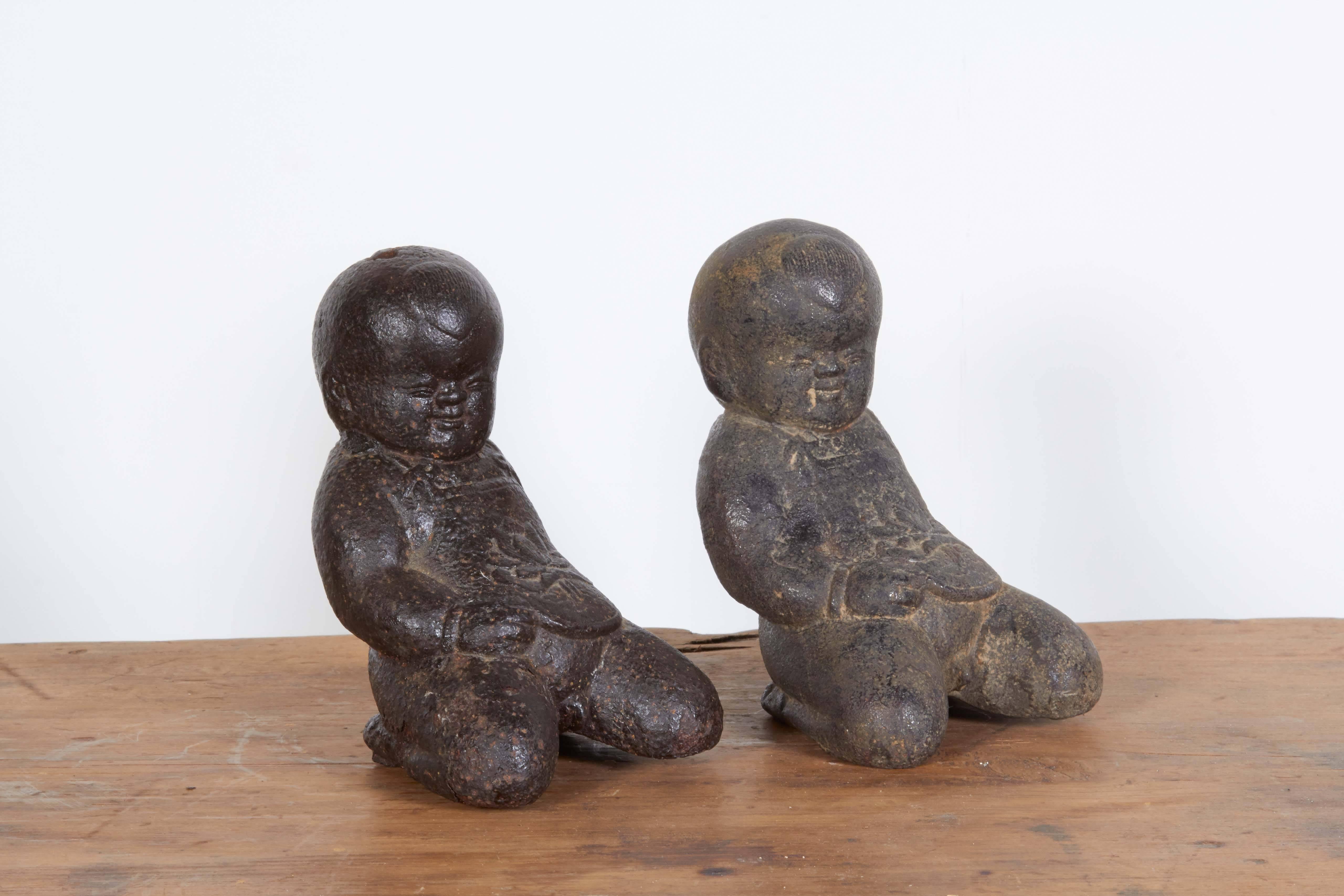 A pair of small, vintage whimsical cast iron Chinese babies that look great from every angle. A great shelf or desk piece, and certainly a terrific gift. From Shanxi province, circa 1940.
M912.