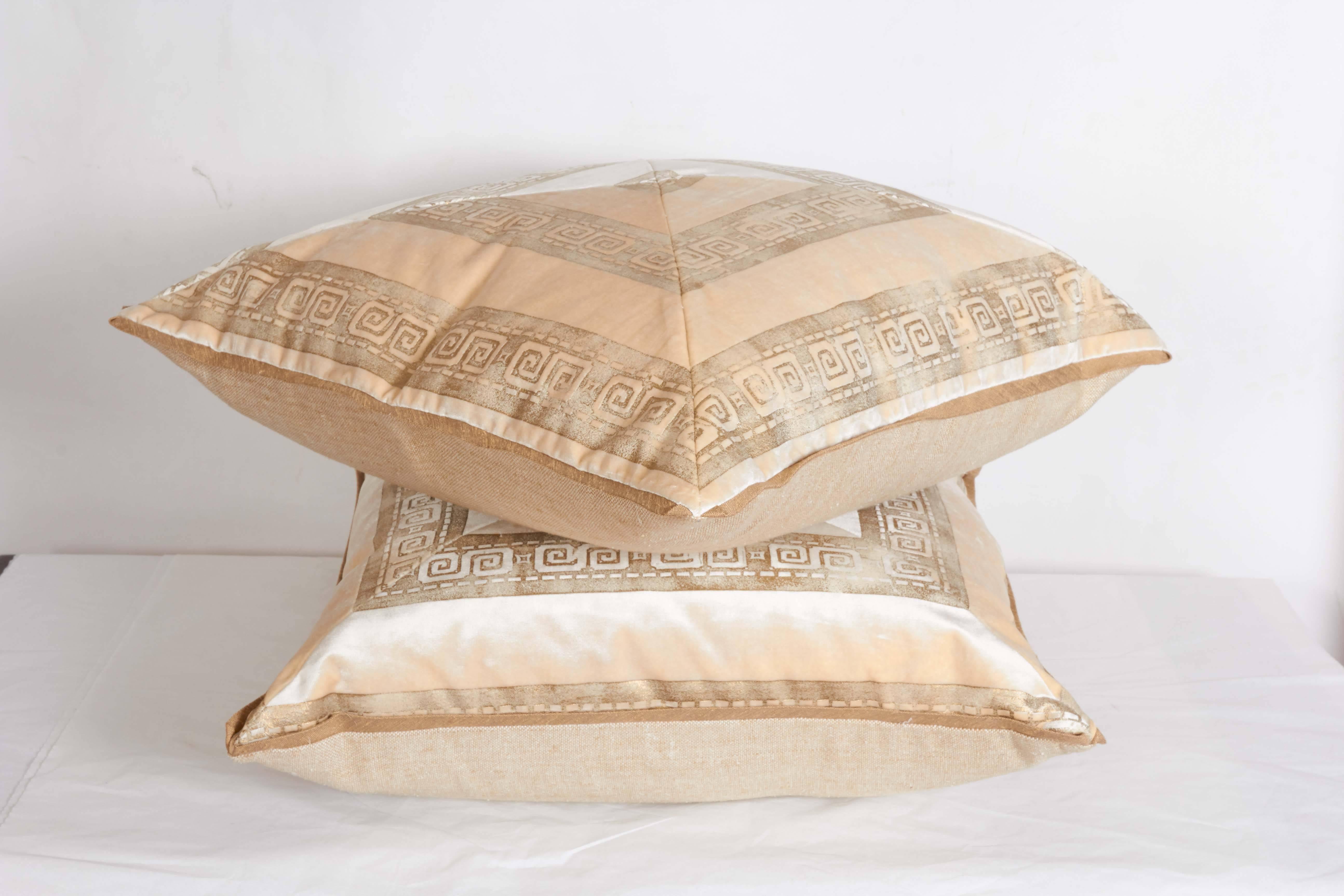 A pair of white and beige cushions with geometric motif, vintage Italian velvet fabric.