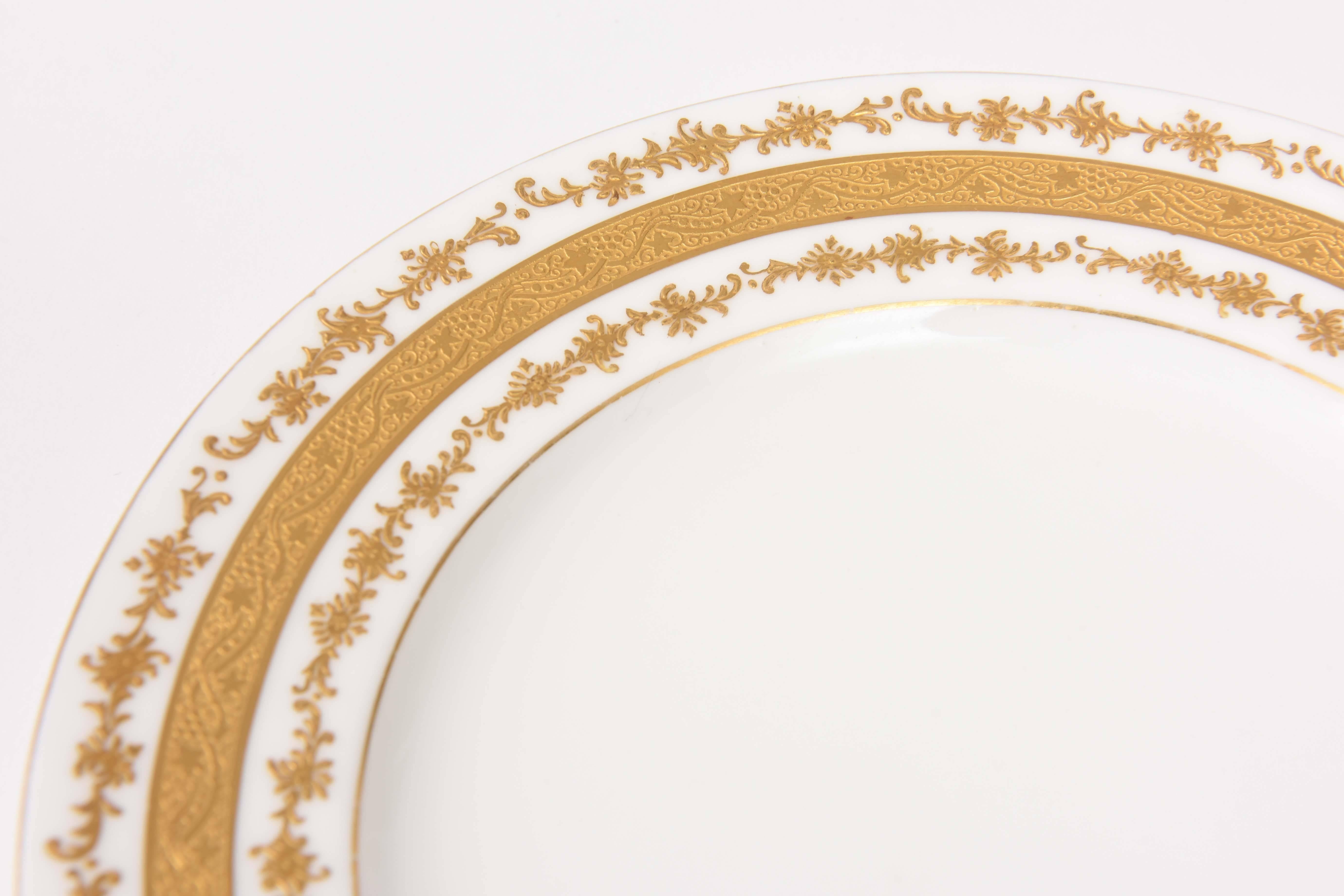 A wonderful size of Coalport, England dessert plates custom ordered through the fine retailer of Tiffany & Co. This plate features crisp white porcelain, 24-karat acid etched band and a double ring of raised paste gold on its shoulder. A perfect