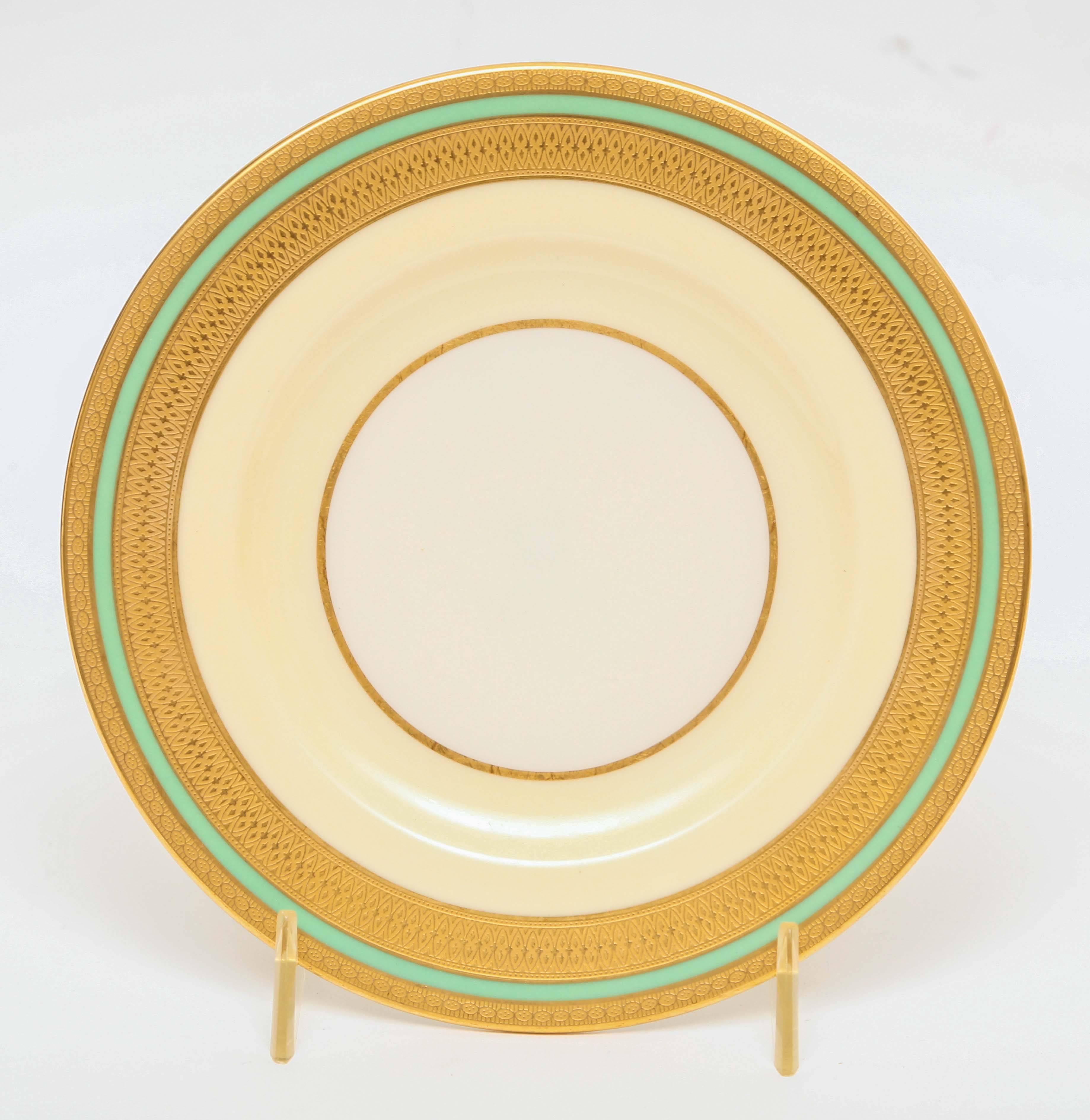 A perfect fine porcelain dinner service for the Holidays as well as year round with its versatile color and crisp textured gilt bands. This set was made by the fine American China firm of Lenox and custom ordered through one of Detroit's luxury