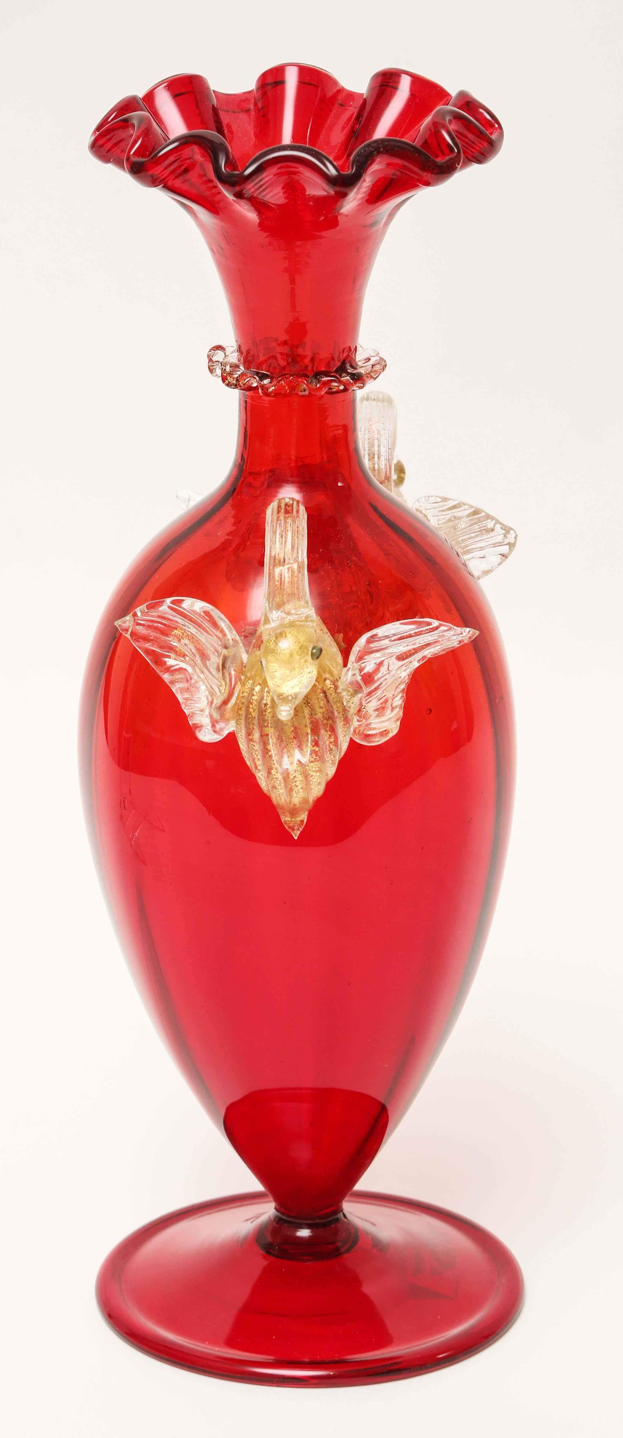 A charming vintage Venetian vase with a nicely blown ruffle edge to its top and extra blown decoration on its collar. Two elegant swan handles and blown 24-karat gold inclusion throughout the clear accents. From the great master glass blowers on the