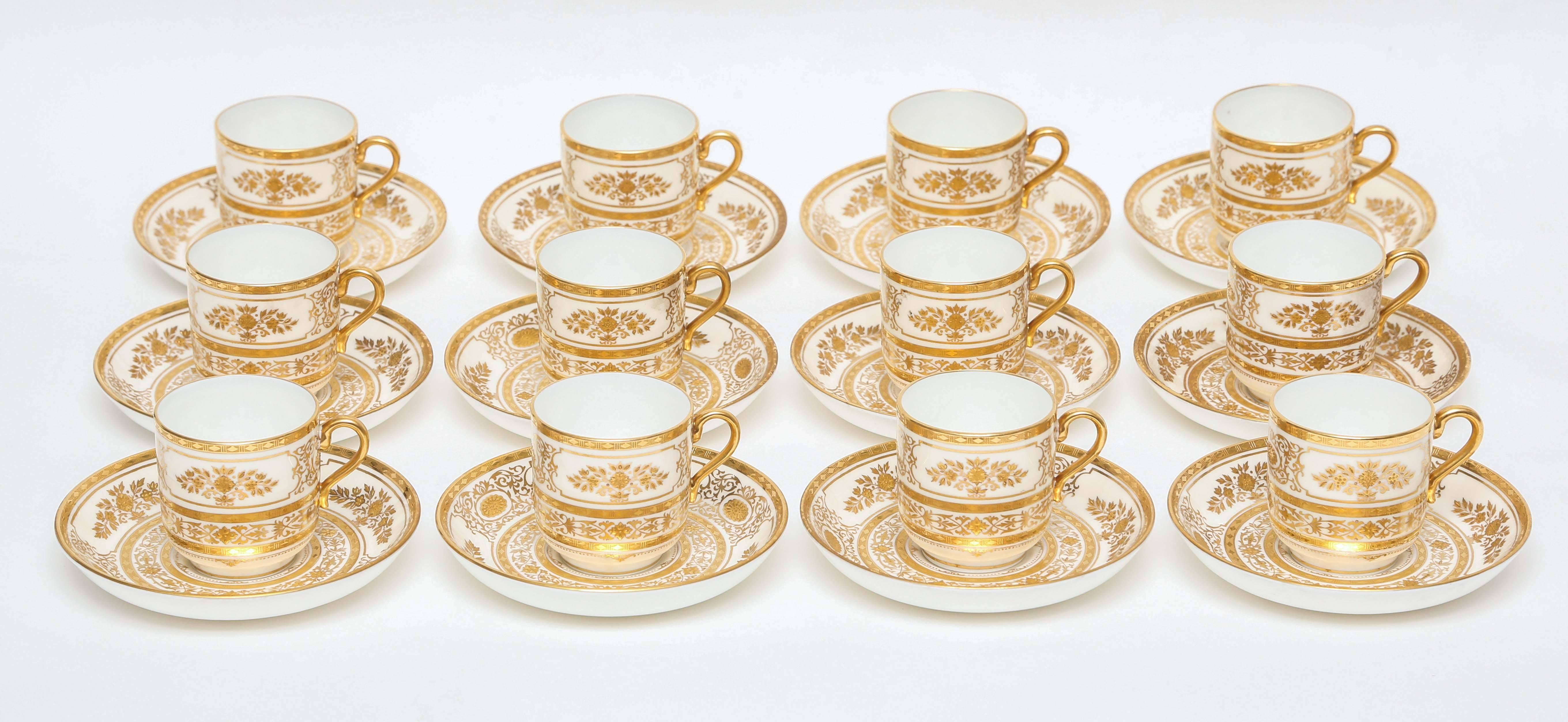 A gorgeous cup and saucer set for your table featuring a raised gilt pattern from Minton, England and custom ordered through the fine retailer of Tiffany & Co New York. Triple etched gilt bands surround a tooled gilt foliate design. The perfect