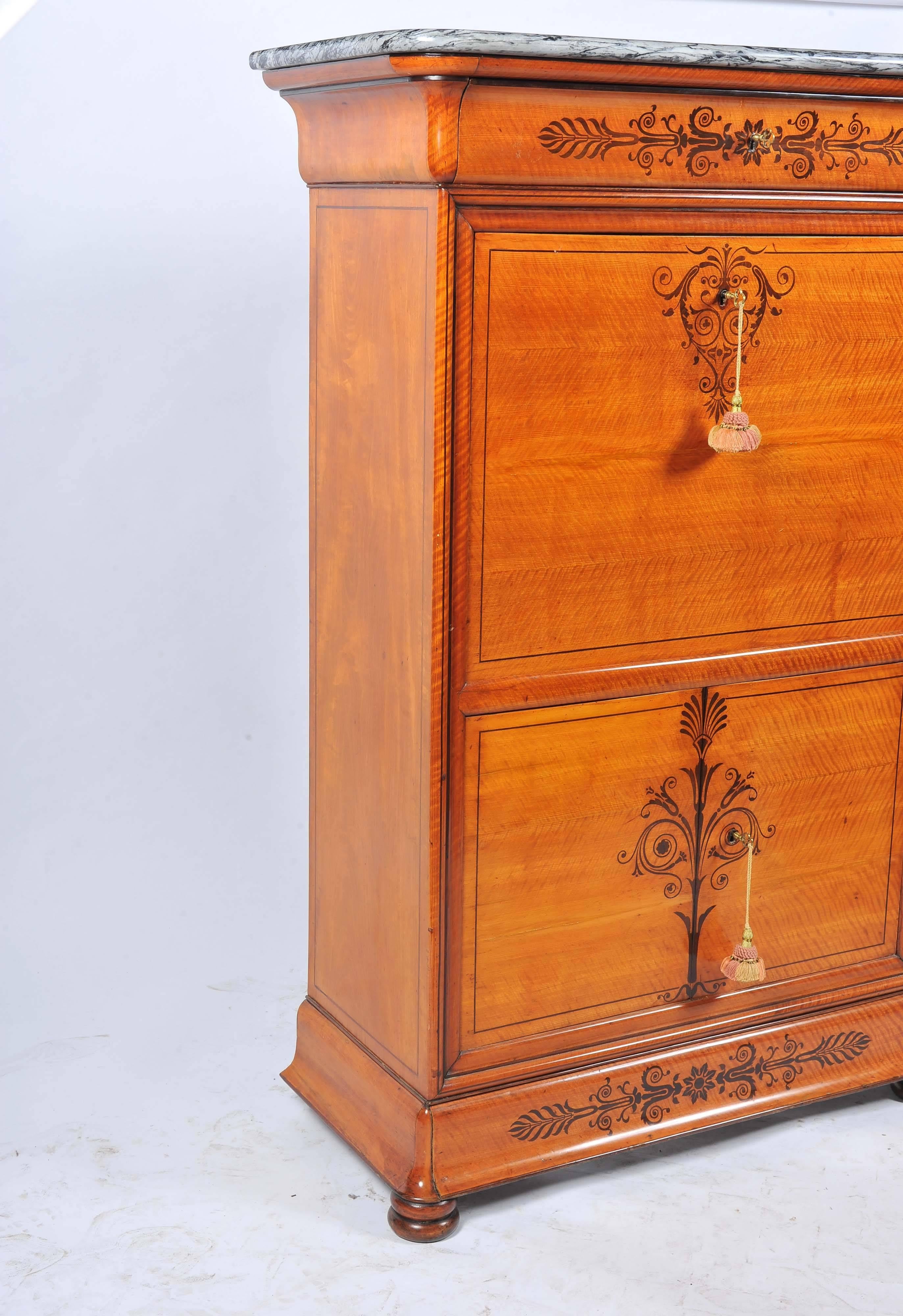 A very good quality French satin birch and rosewood inlaid secretaire abbatant. Having a marble top, a fall front opening to reveal a compartmented interior with drawers, mirrors and an inset leather writing tablet, cupboard doors beneath with a