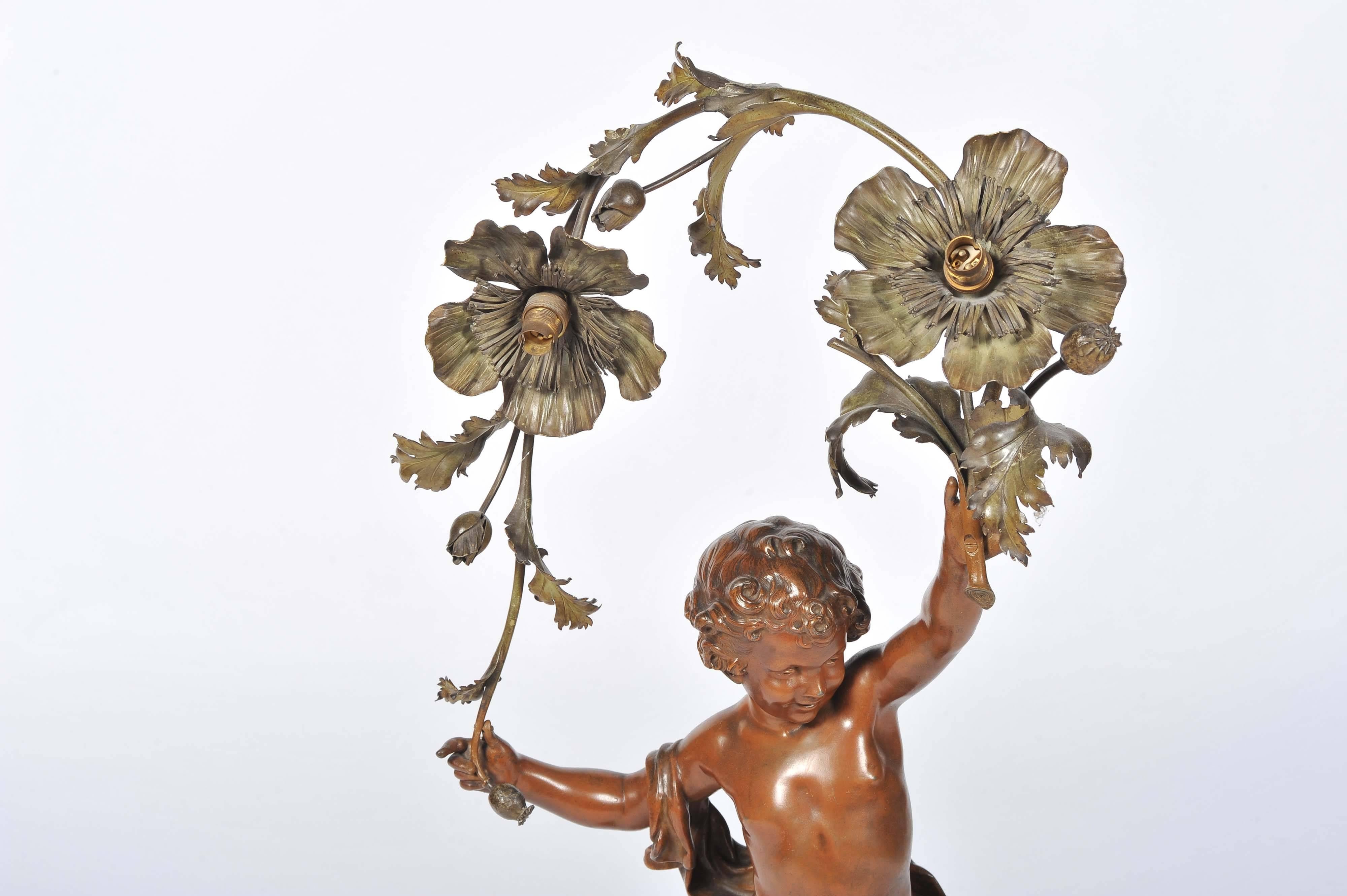 An enchanting 19th century bronze statue of a child hold flowers above its head and raised on a Rouge marble plinth.