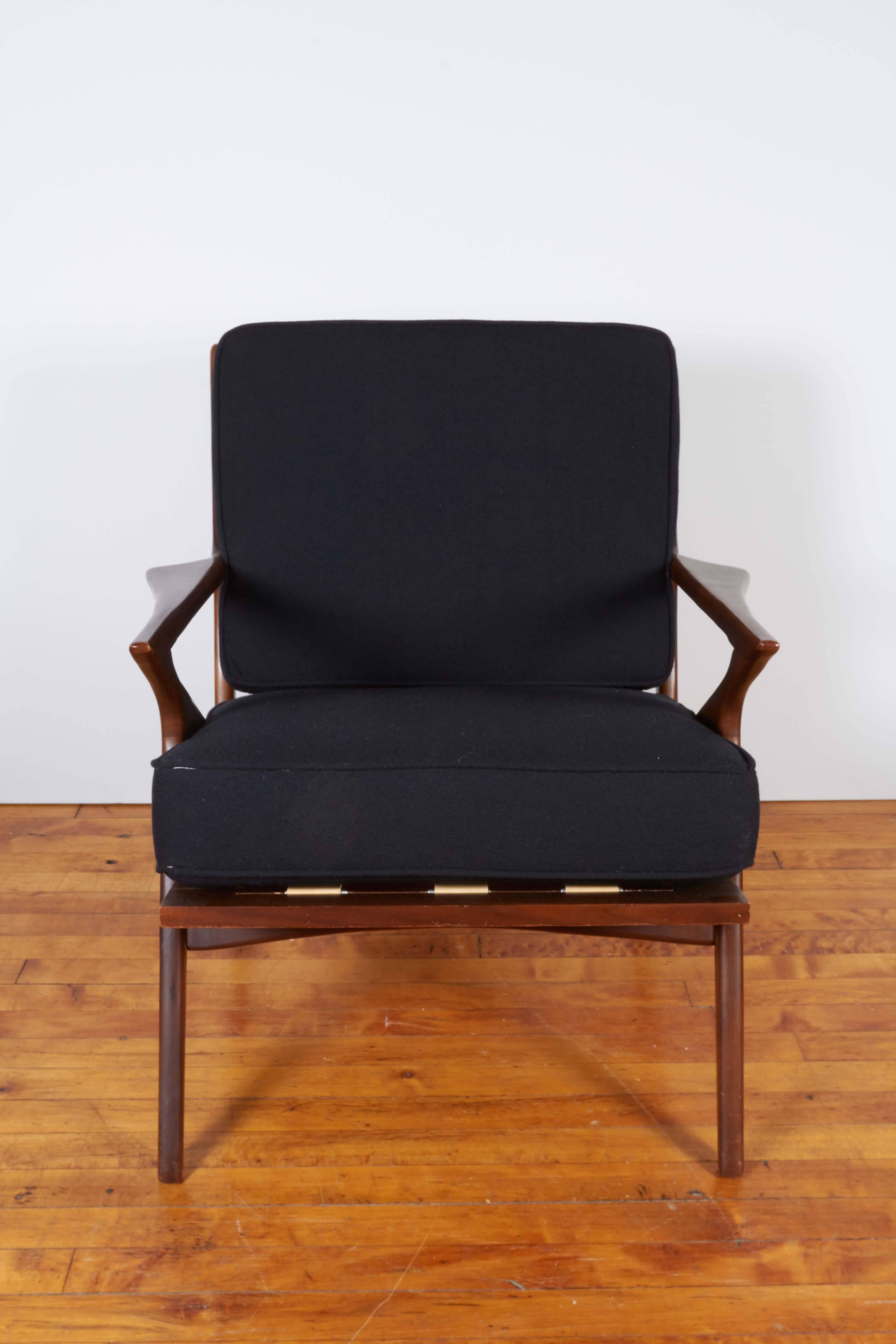 A Danish modern lounge chair designed by Poul Jensen for Selig, manufactured, circa 1960s, with cushioned back and seat in black, against 'Z' frame in rich toned teak. This chair remains in very good vintage condition, consistent with age, newly