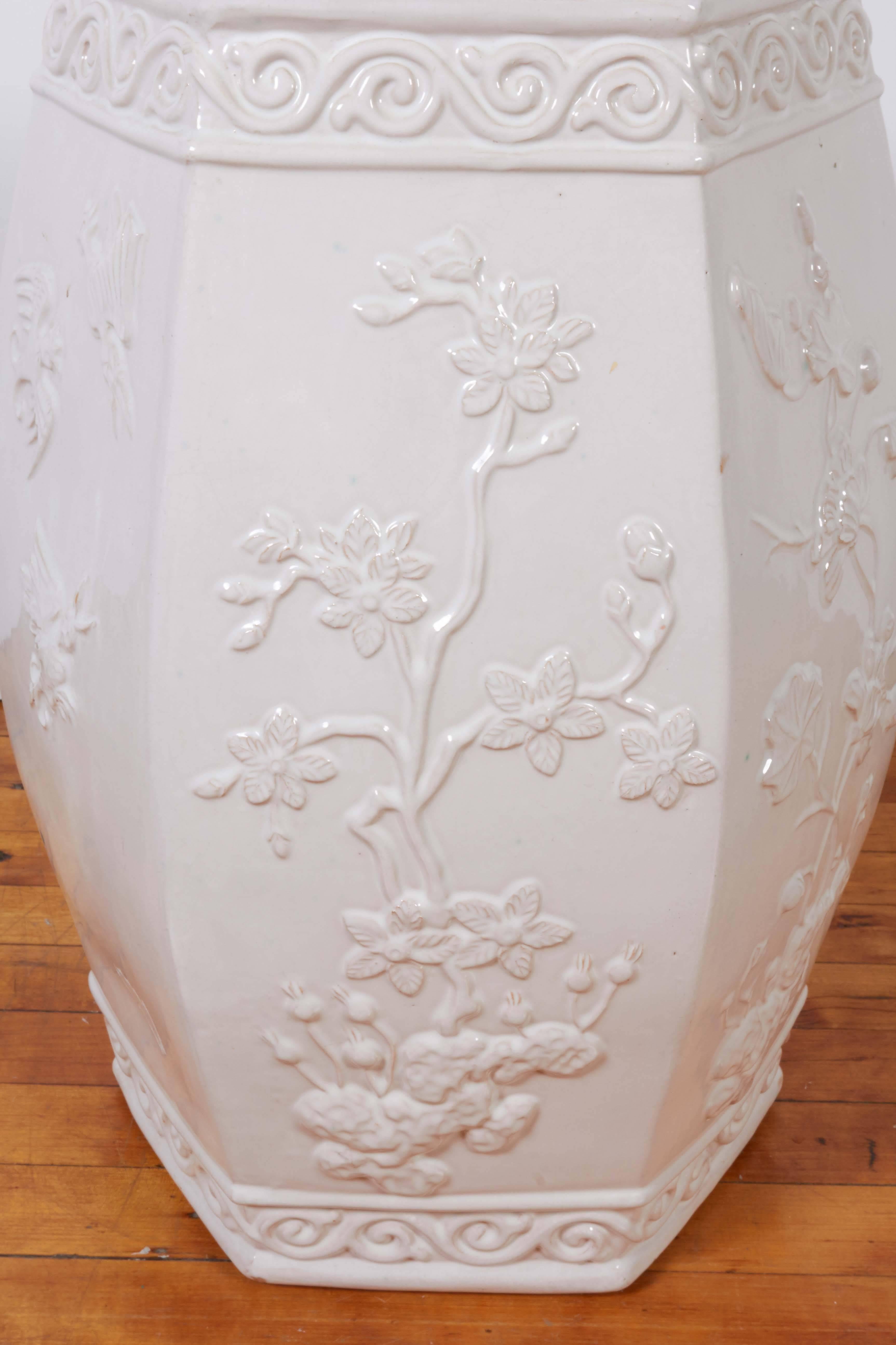 An Italian 1970s hexagonal sided garden seat influenced by the Chinoiserie style and form, detailed with flowering branches in relief, scroll patterned bands to the top and base. Markings include [S. 6181/ Italy] signed to underside. Very good