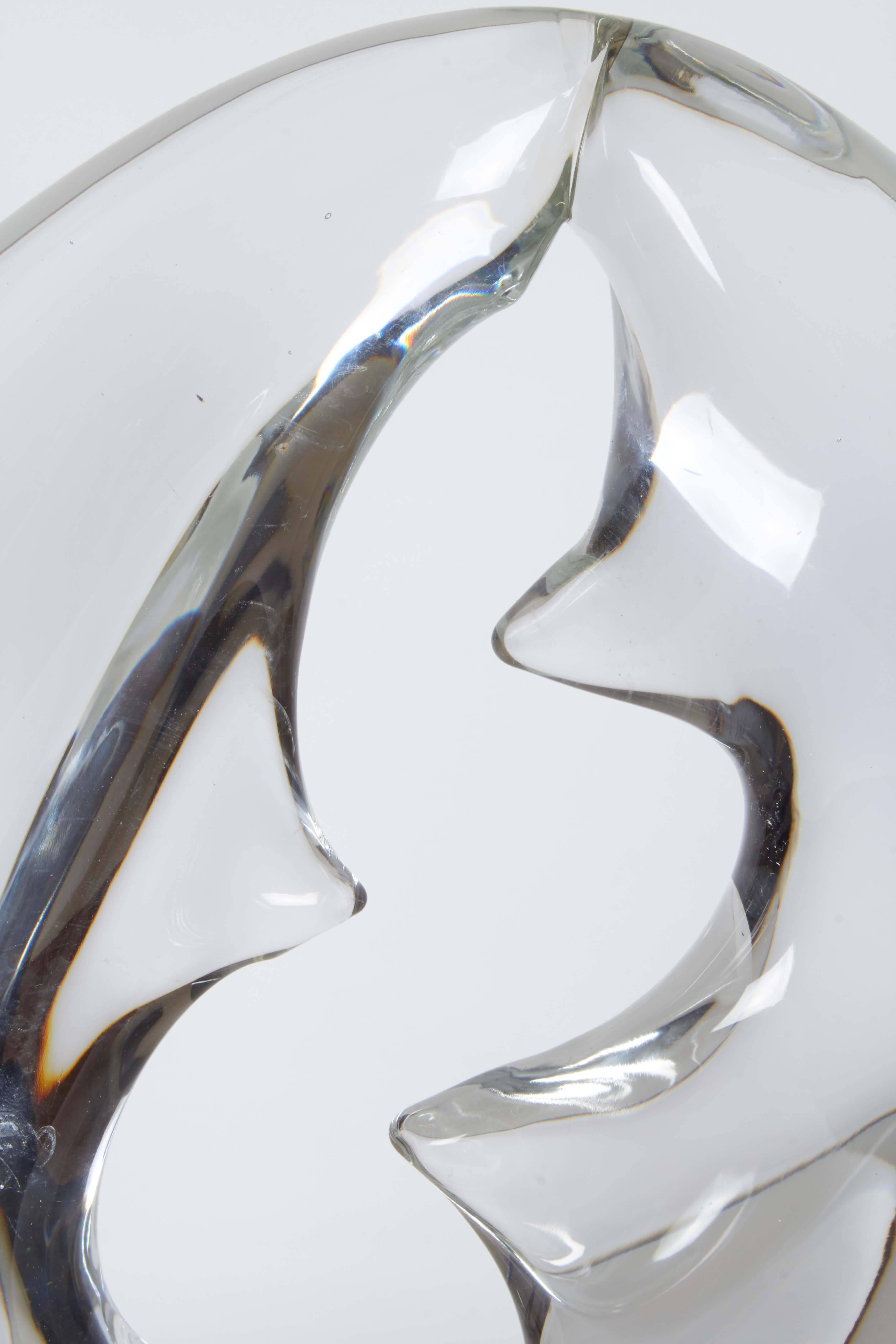 An Italian abstract sculpture in Murano glass, produced circa 1960s by Livio Seguso, depicting two crescent shapes, joined as a ring, on cylindrical frosted base. Markings include signature [L. Seguso] to the underside of the base. Excellent vintage