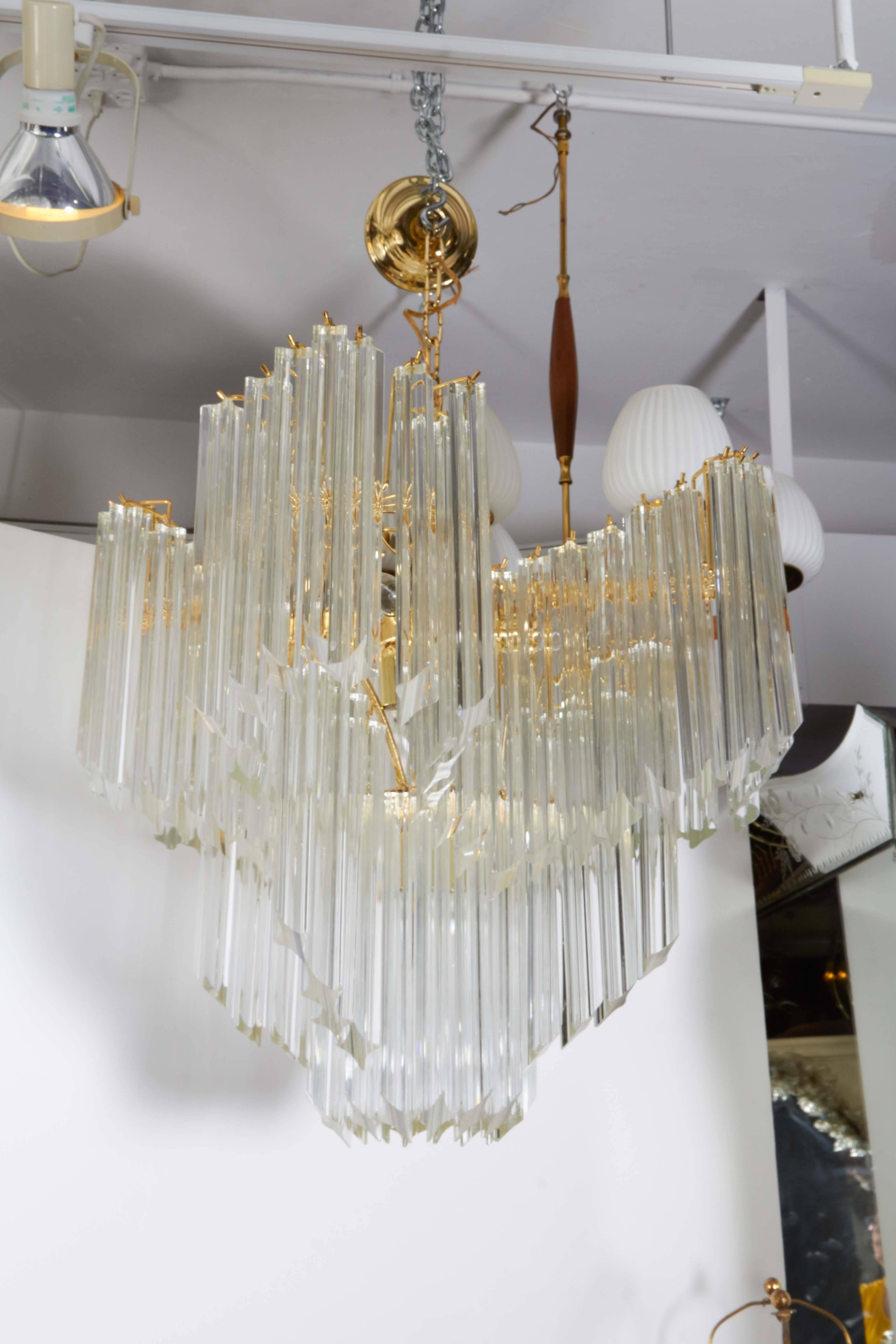A modern style Italian chandelier by Venini, produced circa 1970s, with Murano glass quatro punta prisms, suspended from an elaborate star form brass frame. Very good vintage condition, wear consistent with age and use.

10773