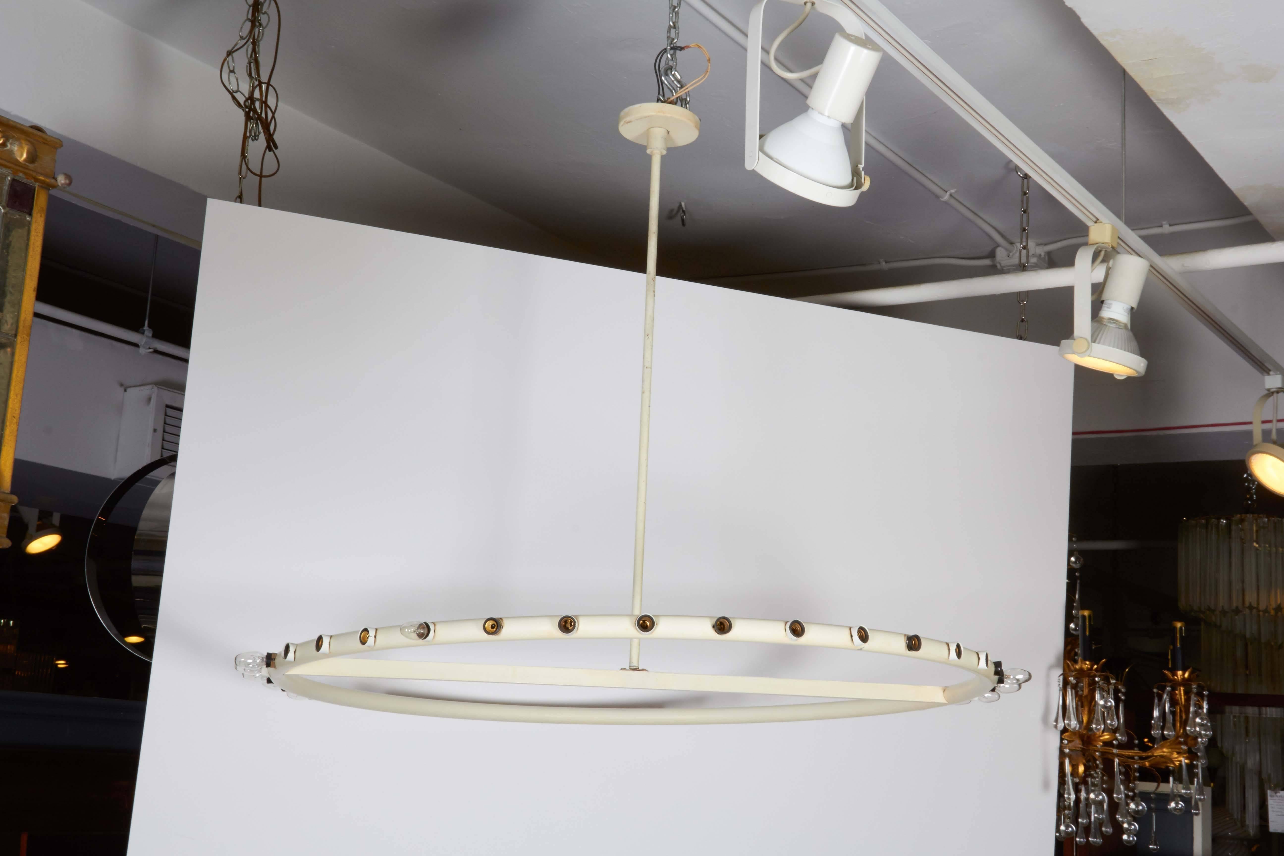 A modern style ring form chandelier by American designer Alvin Lustig, manufactured by Lightolier, circa 1950s, the frame, comprised of white enameled metal, surrounded by light sockets. Despite minor loss of socket covers, this light fixture