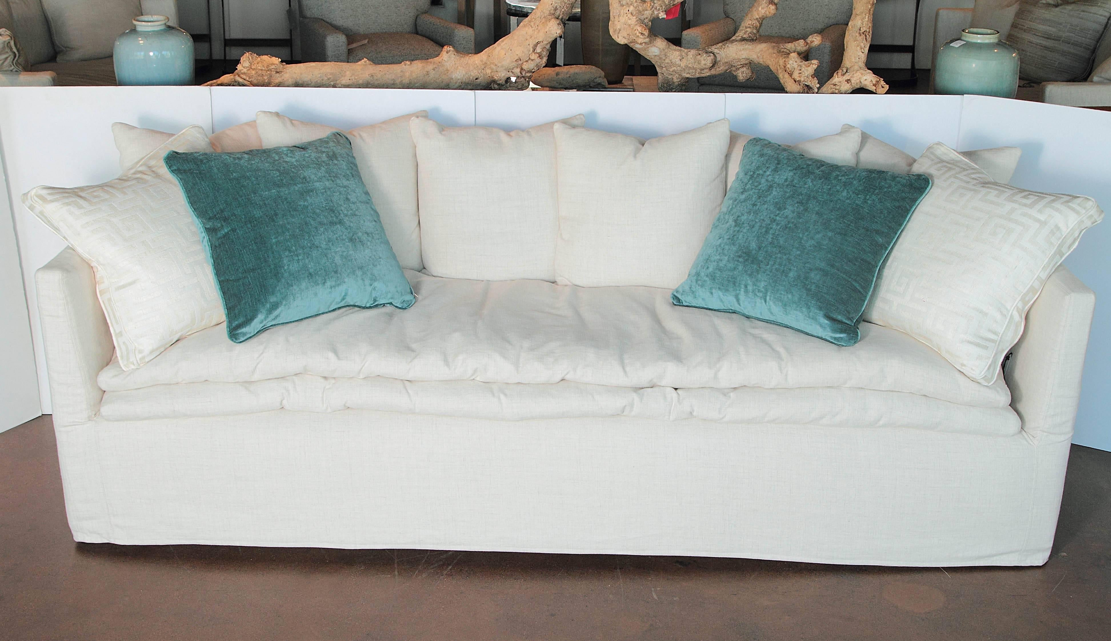 Egg shell white coverall sofa.
Brand: LEE. 

Slipped cover sofa with extra cushion added. Including six pillows. Cushion down pillow top. Finish is fruitwood.

Fabric is 