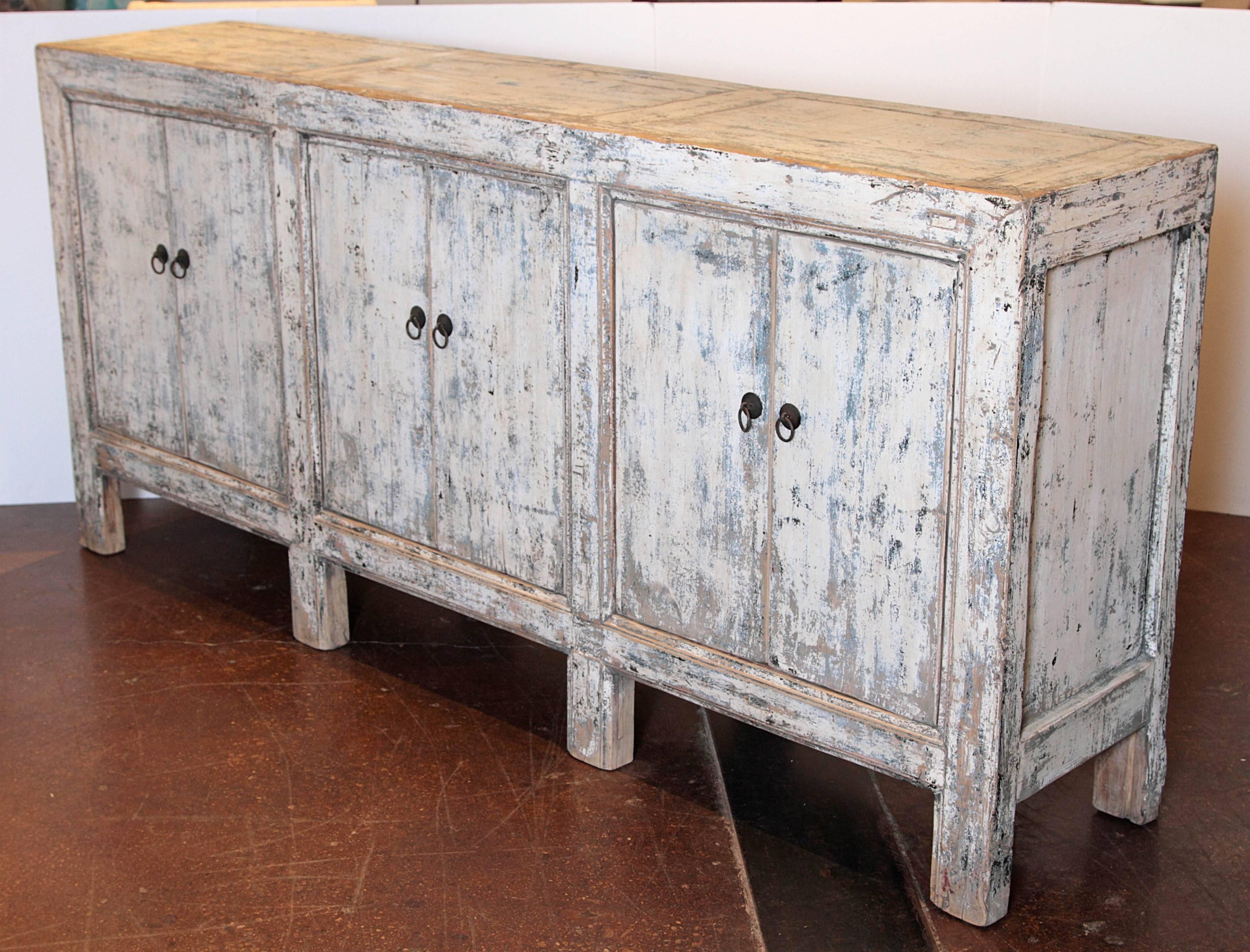 Six-door white distressed sideboard. 

Antique, Belgium 1920s sideboard with six doors. 
Natural distressed white patina, been wax to enhance it's natural shine.