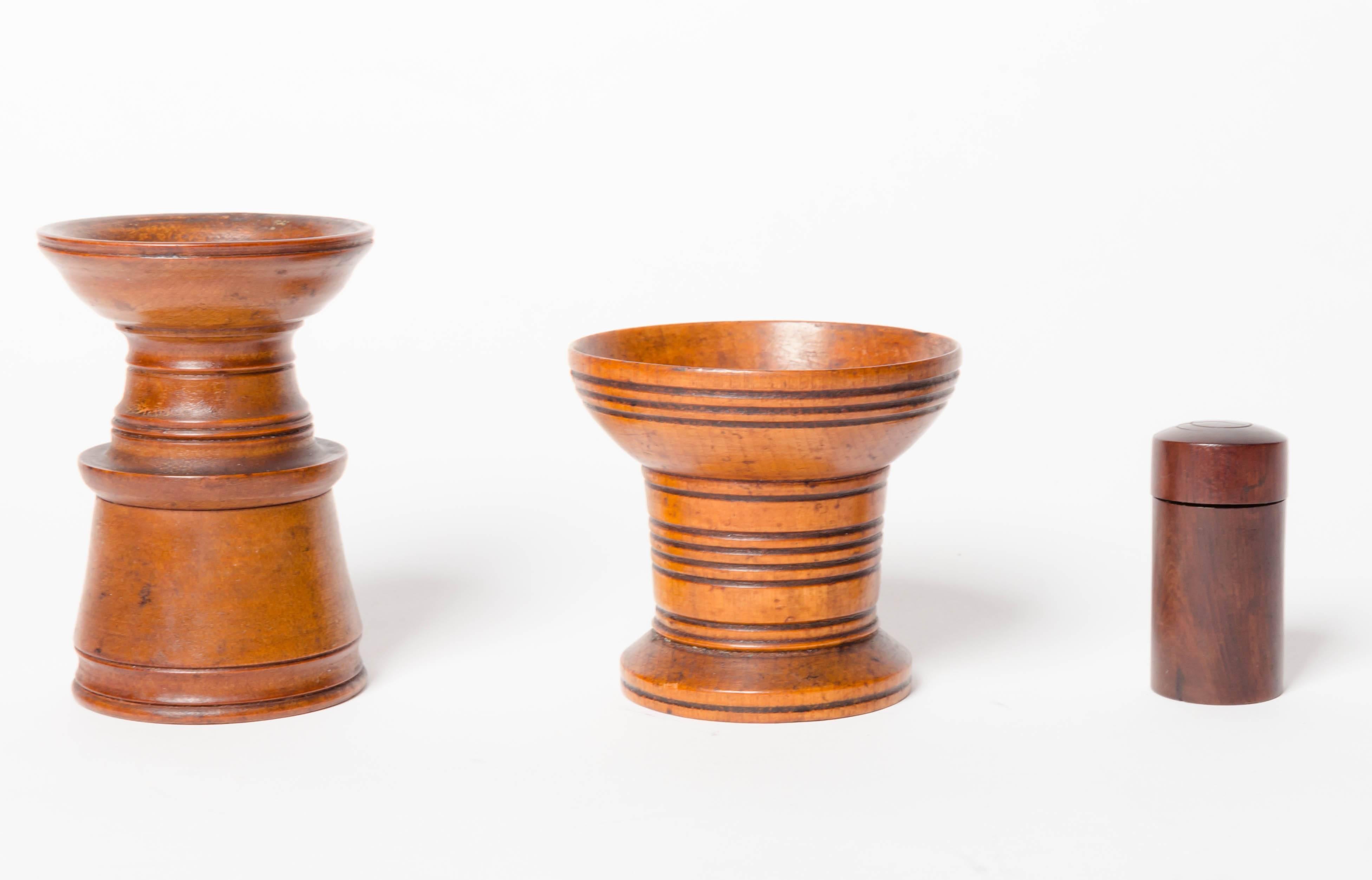 19th century English Treen collection. Consisting of two boxwood pounce pots (ink blotting shaker) and rosewood glass lined inkwell with screw cap. The pounce pots are 4